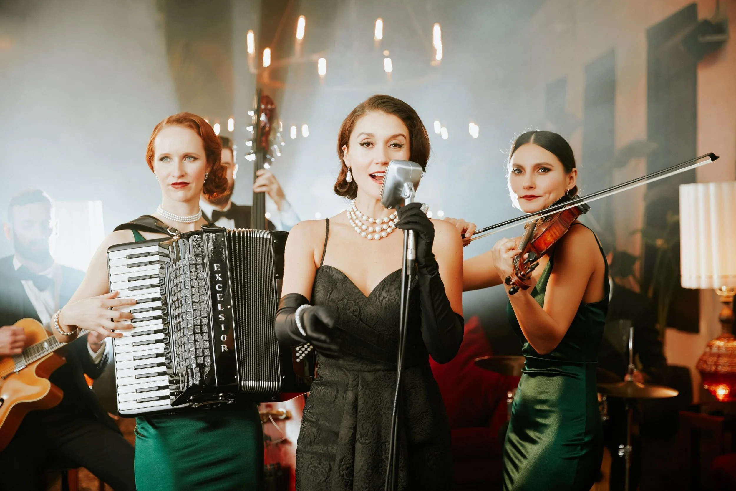 All-female band performing live at a wedding, featuring a singer, violinist, and accordion player, creating an elegant and vibrant atmosphere for a luxury event on the French Riviera.