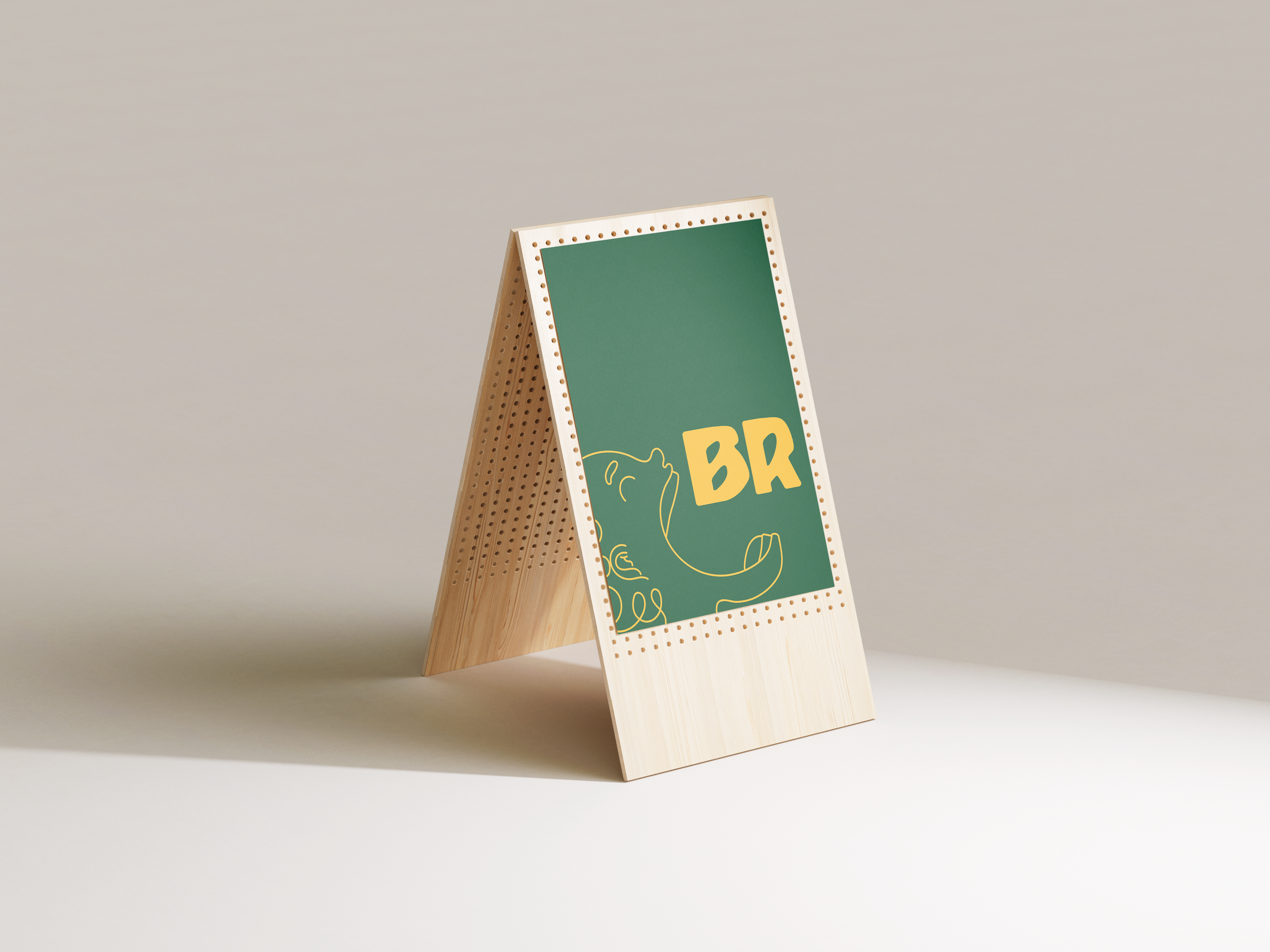 A wooden A-frame sign with a green background displaying a simple line drawing of a curly-haired person opening its mouth to the letters 'BR' in yellow.