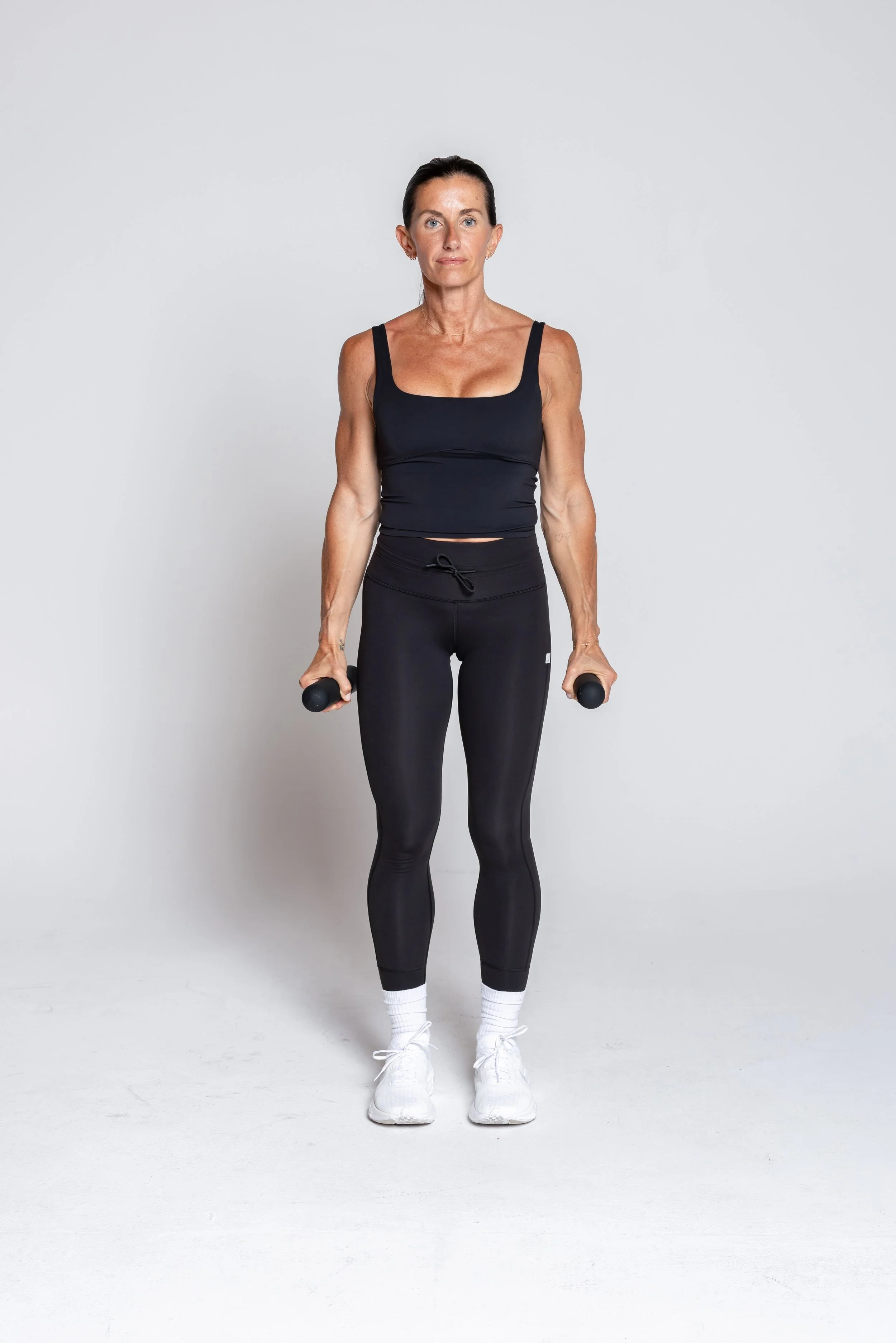 Hammer Curl - Hold bars at your sides, palms facing in. Bend elbows to lift the weights toward your shoulders. Lower with control. Keep elbows close, core engaged.