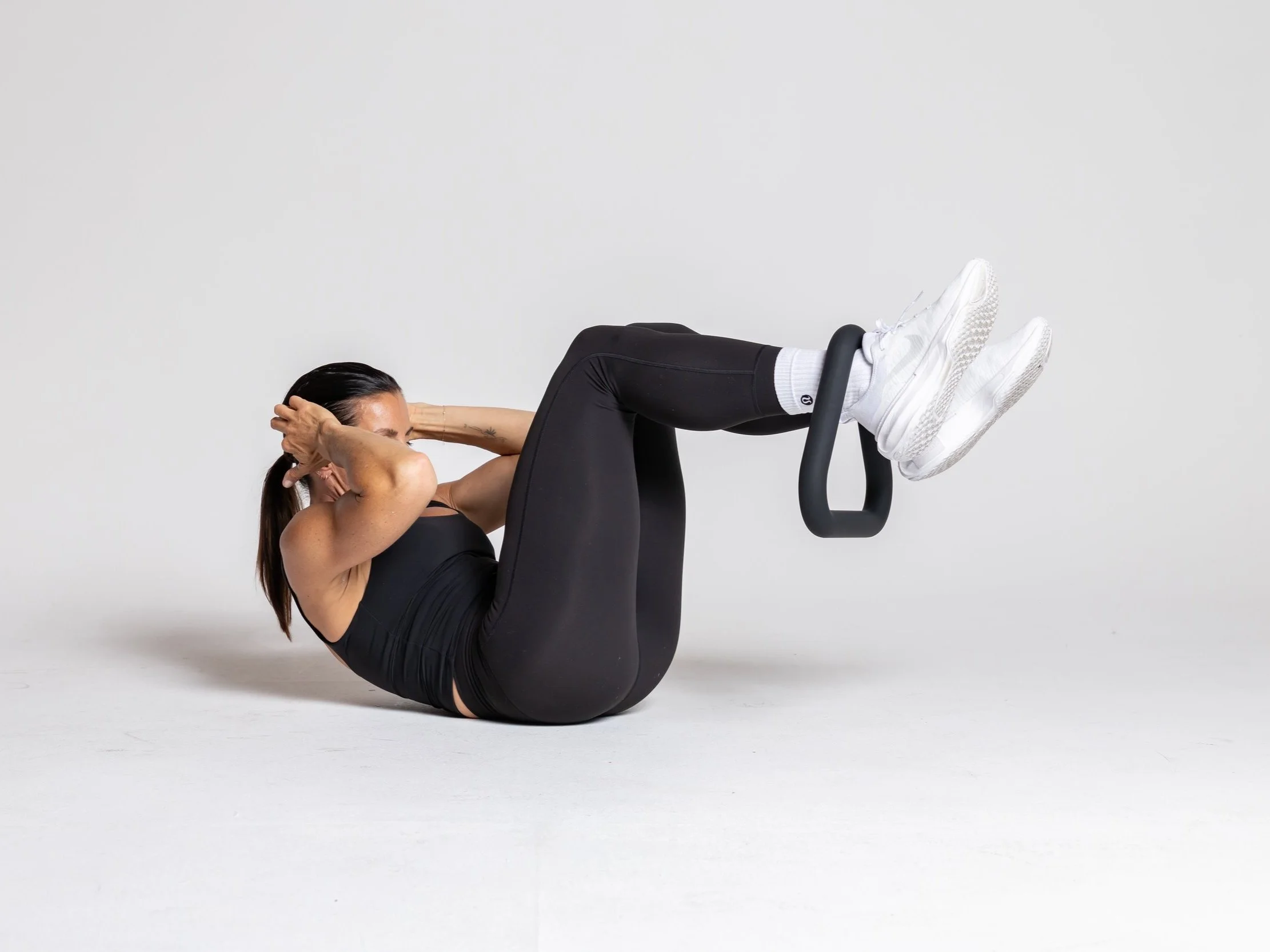 Table Top Crunch - hang the triangle from one or both legs, keep legs in a still table top position, crunch elbows towards knees and then release.