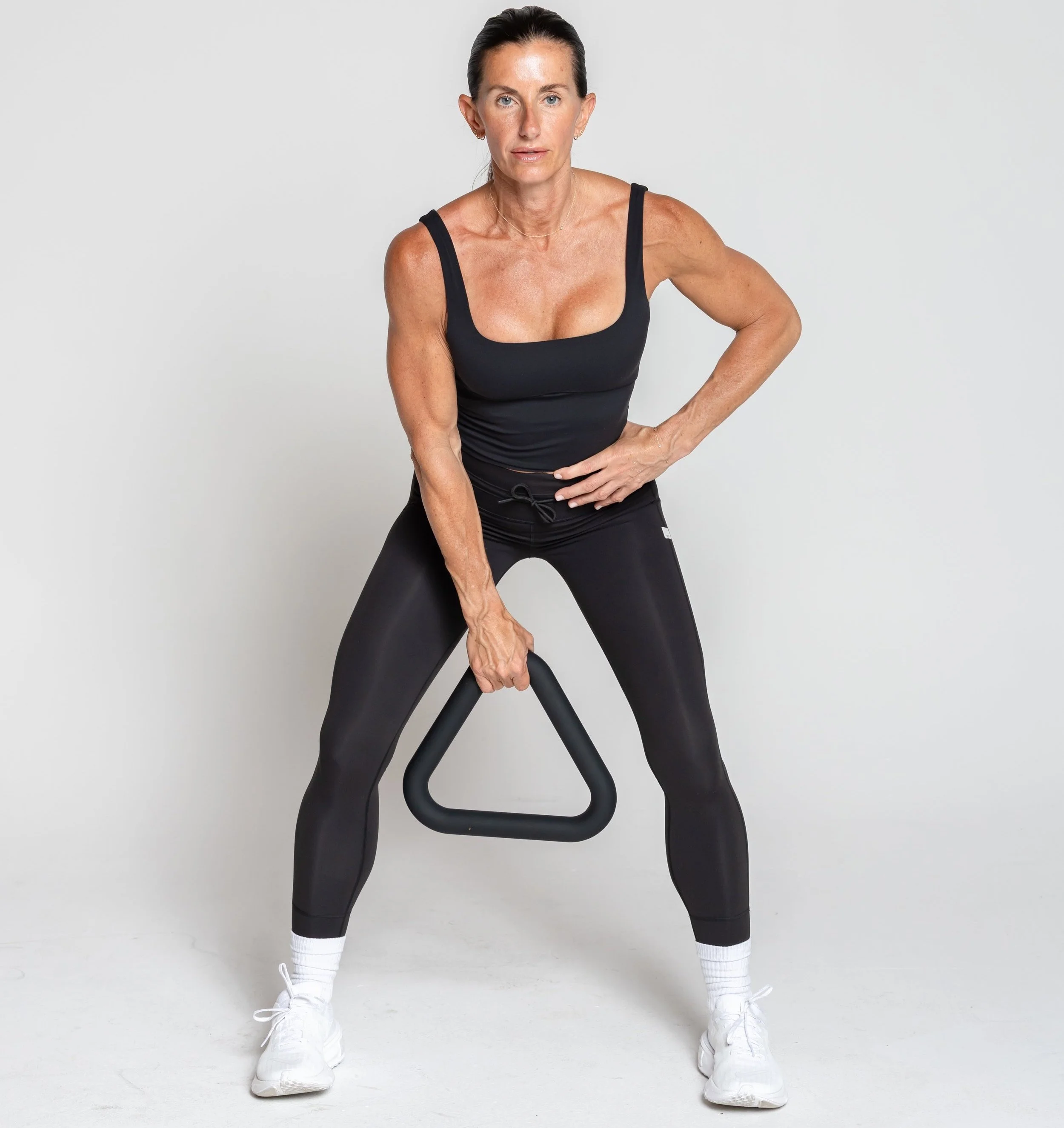 Hip hinge swing - feet shoulder with apart, triangle hangs, push hips back and let tri swing between legs, thrust hips forward quickly, bringing the tri to chest height, arms relaxed hips and glutes do all the work.