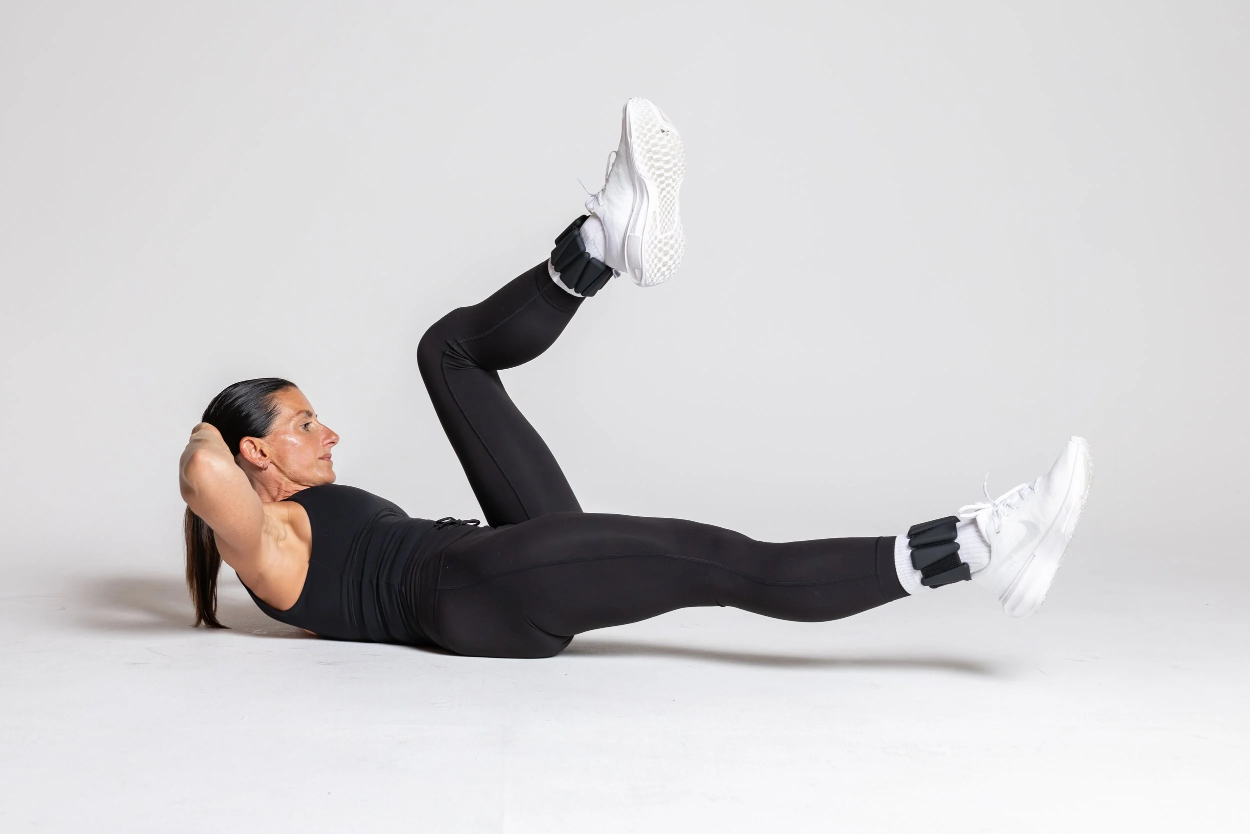 Bent Knee Flutter Kick - Extend both legs off the ground and slowly flutter kick, alternating legs — one lifts toward 90°, the other lowers.