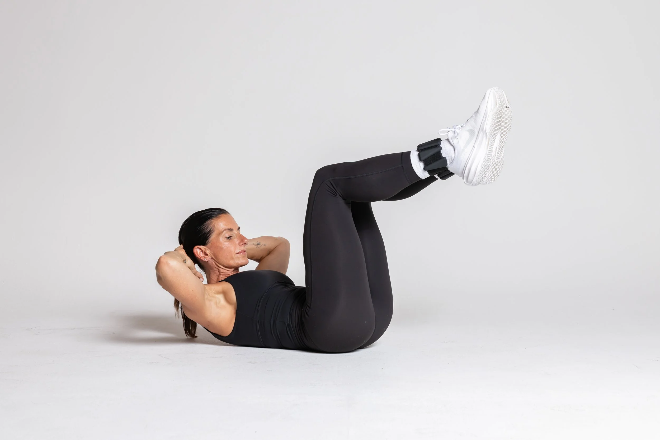 Bent-Knee Crunch with Ankle Weights – Knees up, crunch in. Extra load, extra gain.