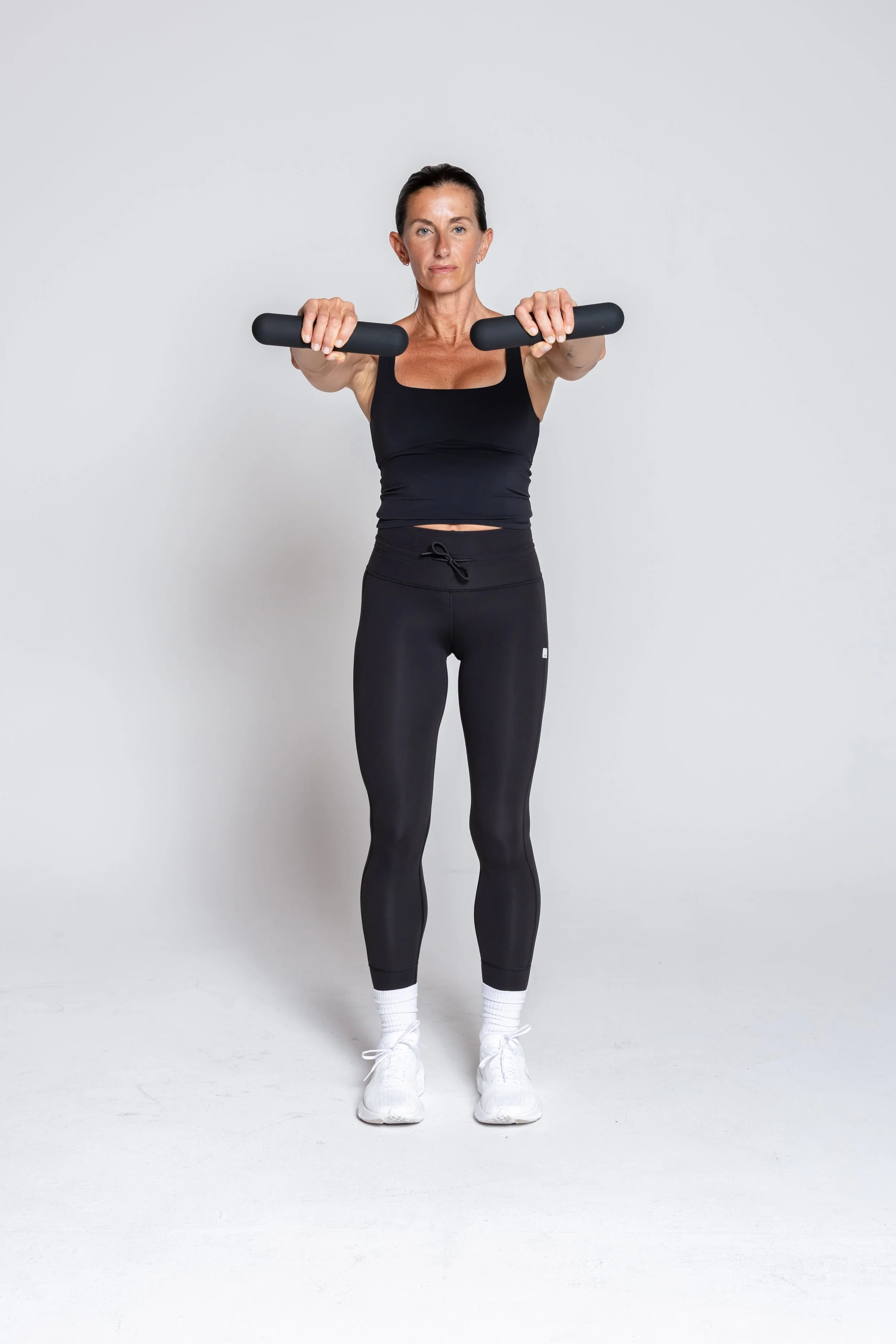 Front Raise – Hold the bar and lift it straight in front of you. Keep your core engaged.