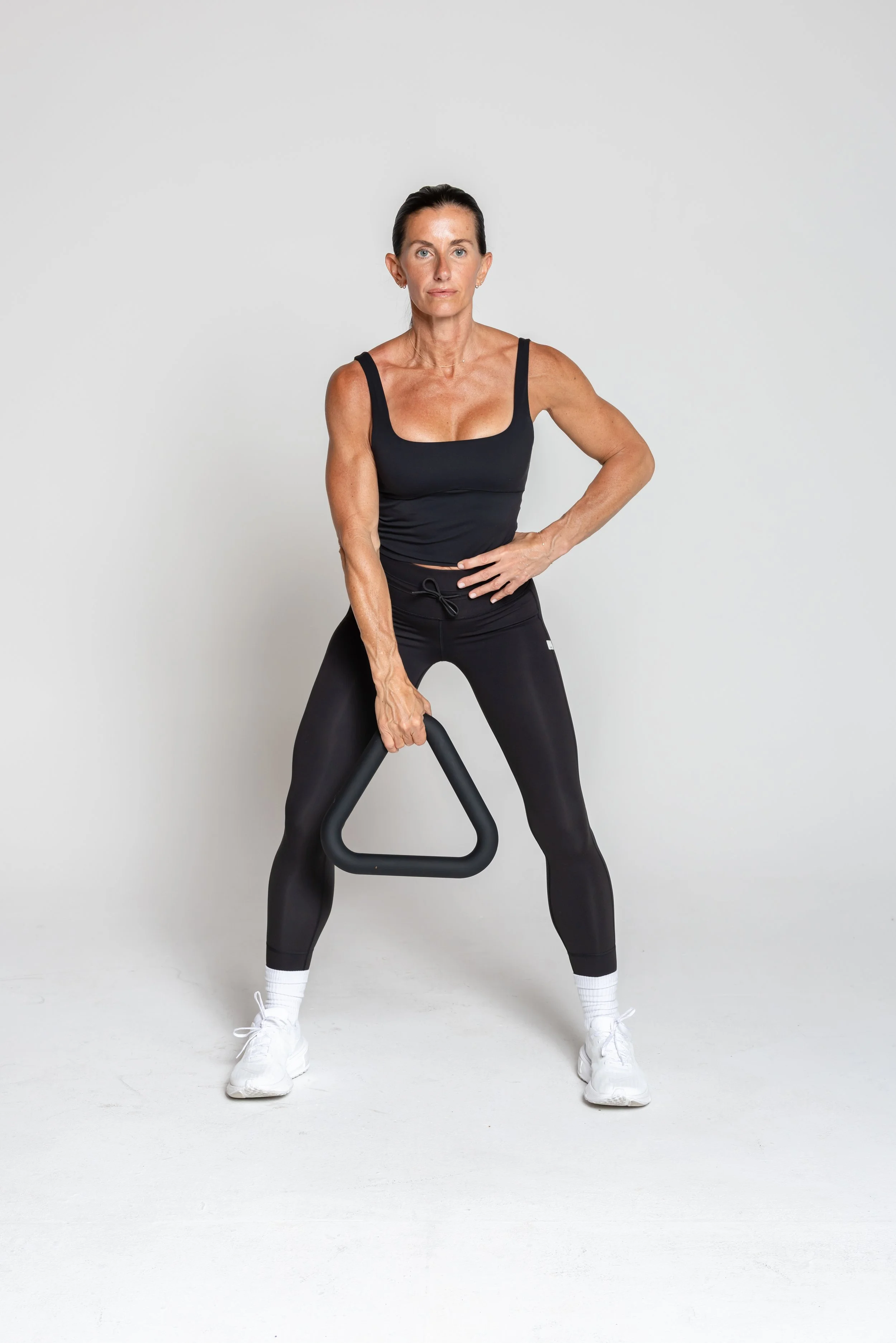 Single-arm Upright Row - Hold the triangle in one hand. Pull it up along your body to chest height, elbow leading. Lower with control. Keep core tight and shoulders relaxed.