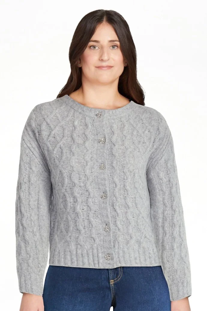 Woman wearing high-waisted light blue wide-leg jeans with a white top and black shoes.