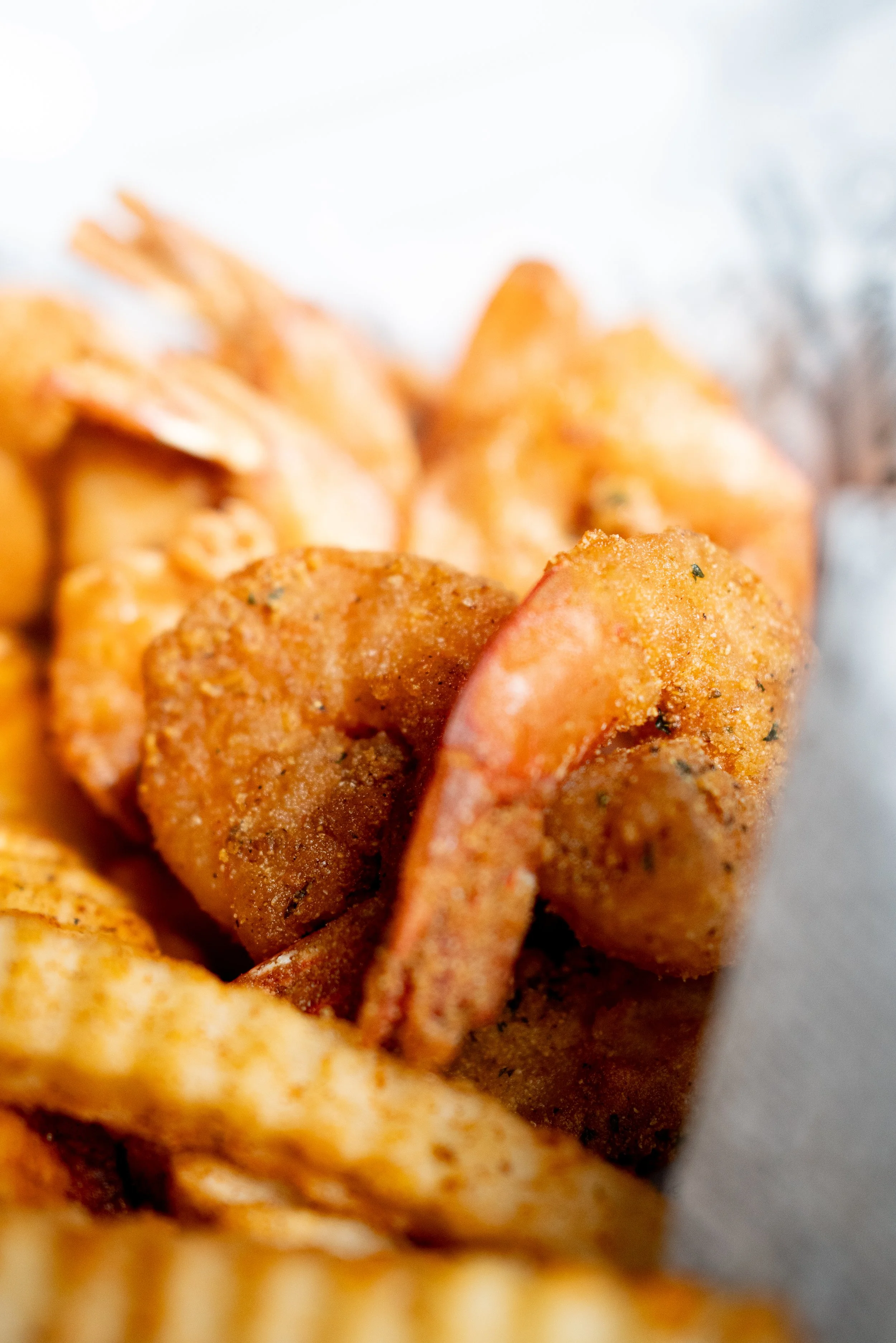 Close-up of seasoned fried shrimp with a crispy coating.