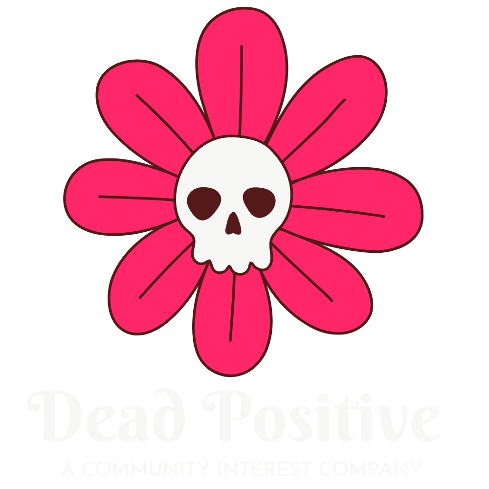 A stylized pink flower with a white skull at its center, accompanied by the text "Dead Positive" and the tagline "A Community Interest Company" underneath.