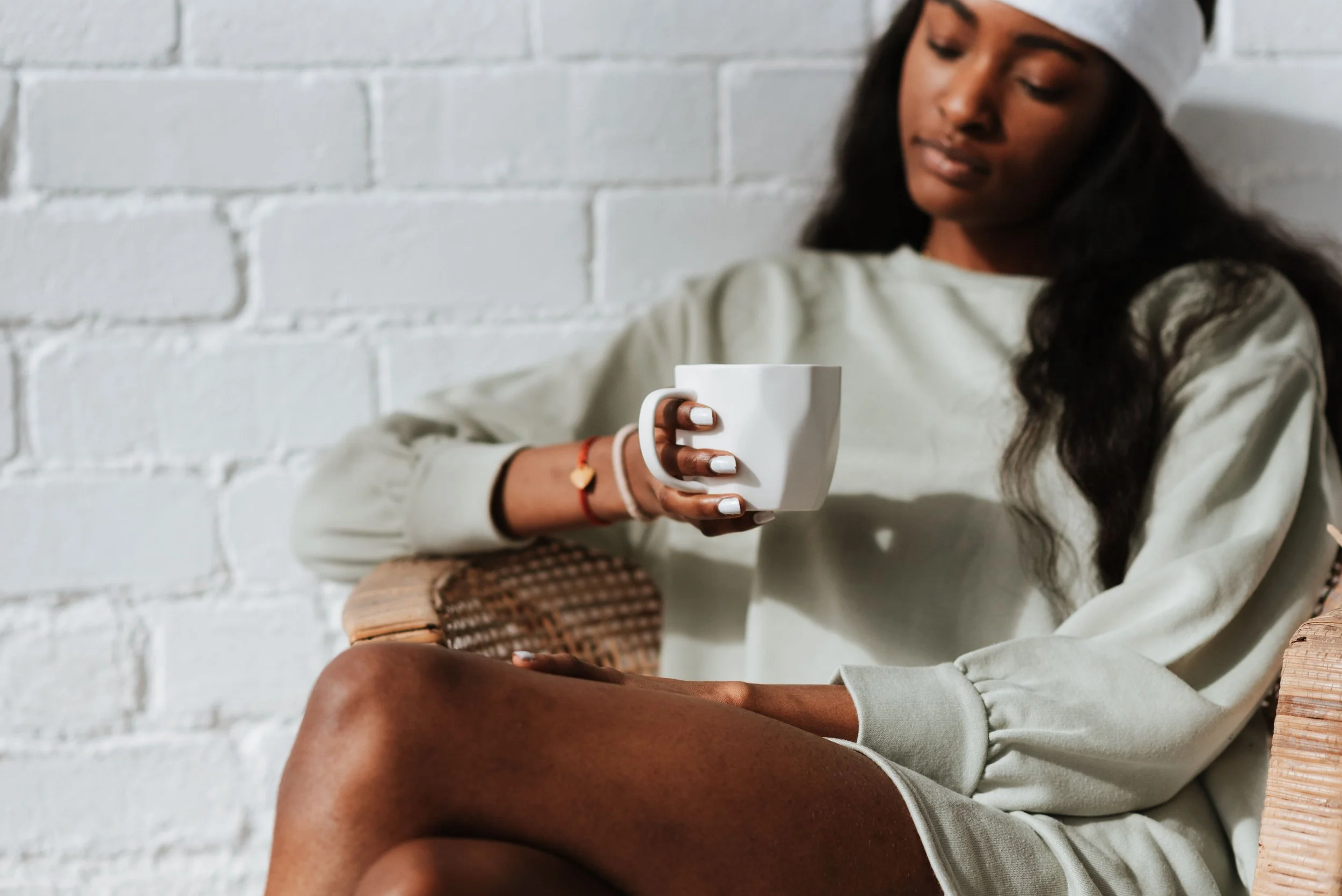 morning-therapy.jpg	Woman holding a warm cup of tea in a quiet interior, soft morning light.