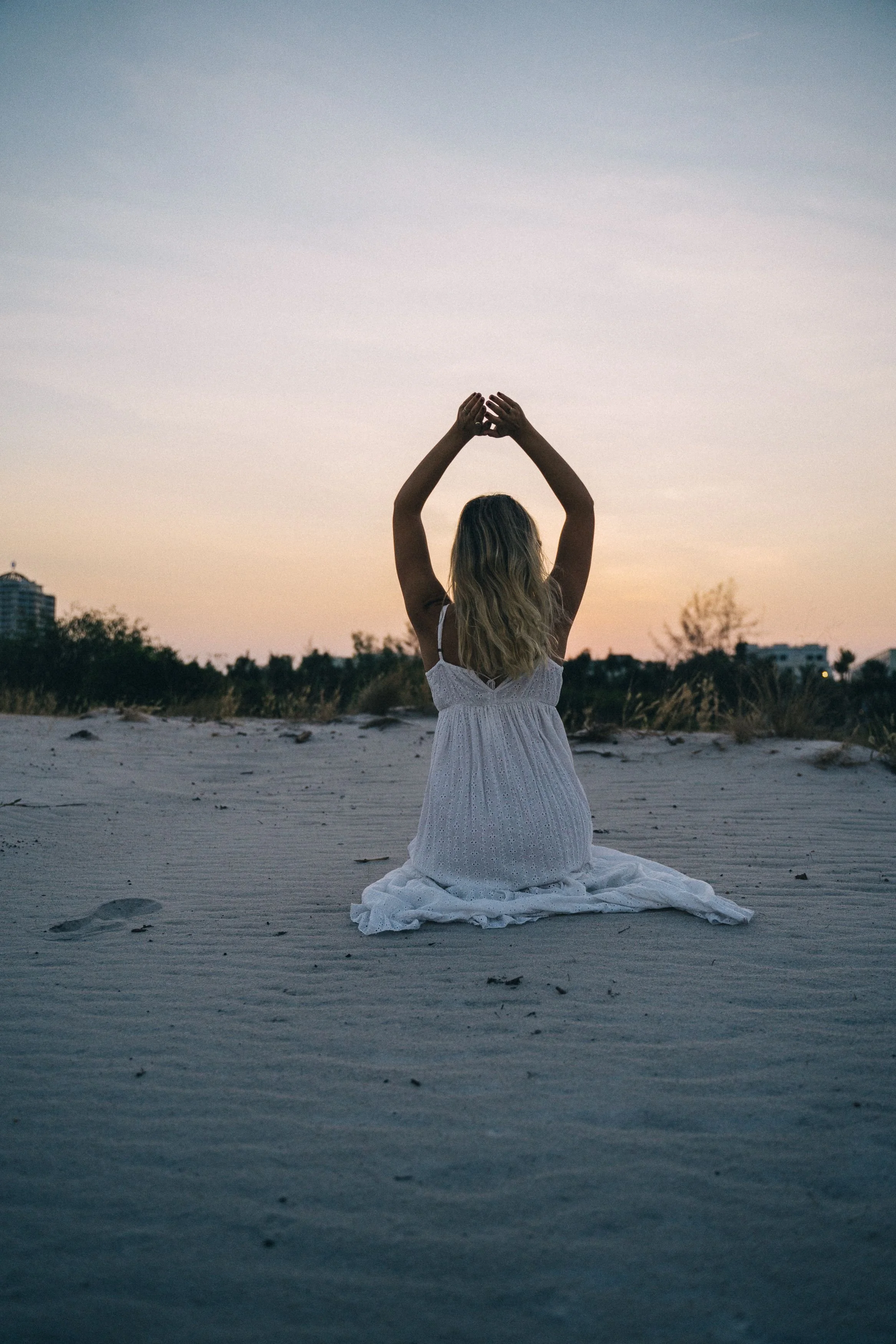 california-wellness.jpg	Woman stretching on the beach in soft morning light, California coastal setting.