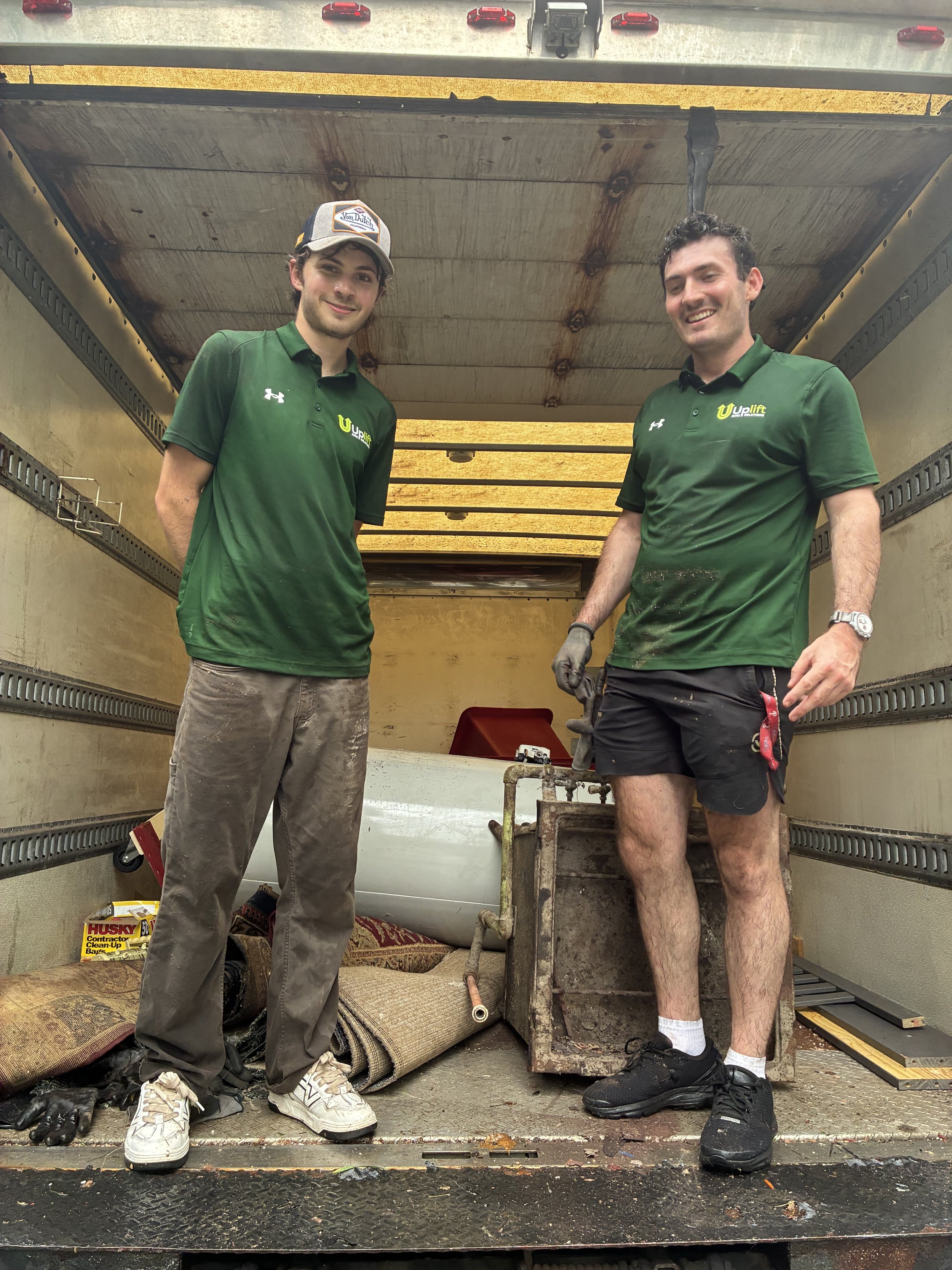 UpLift Junk Solutions crew hauling construction debris from a renovation site in Center City Philadelphia