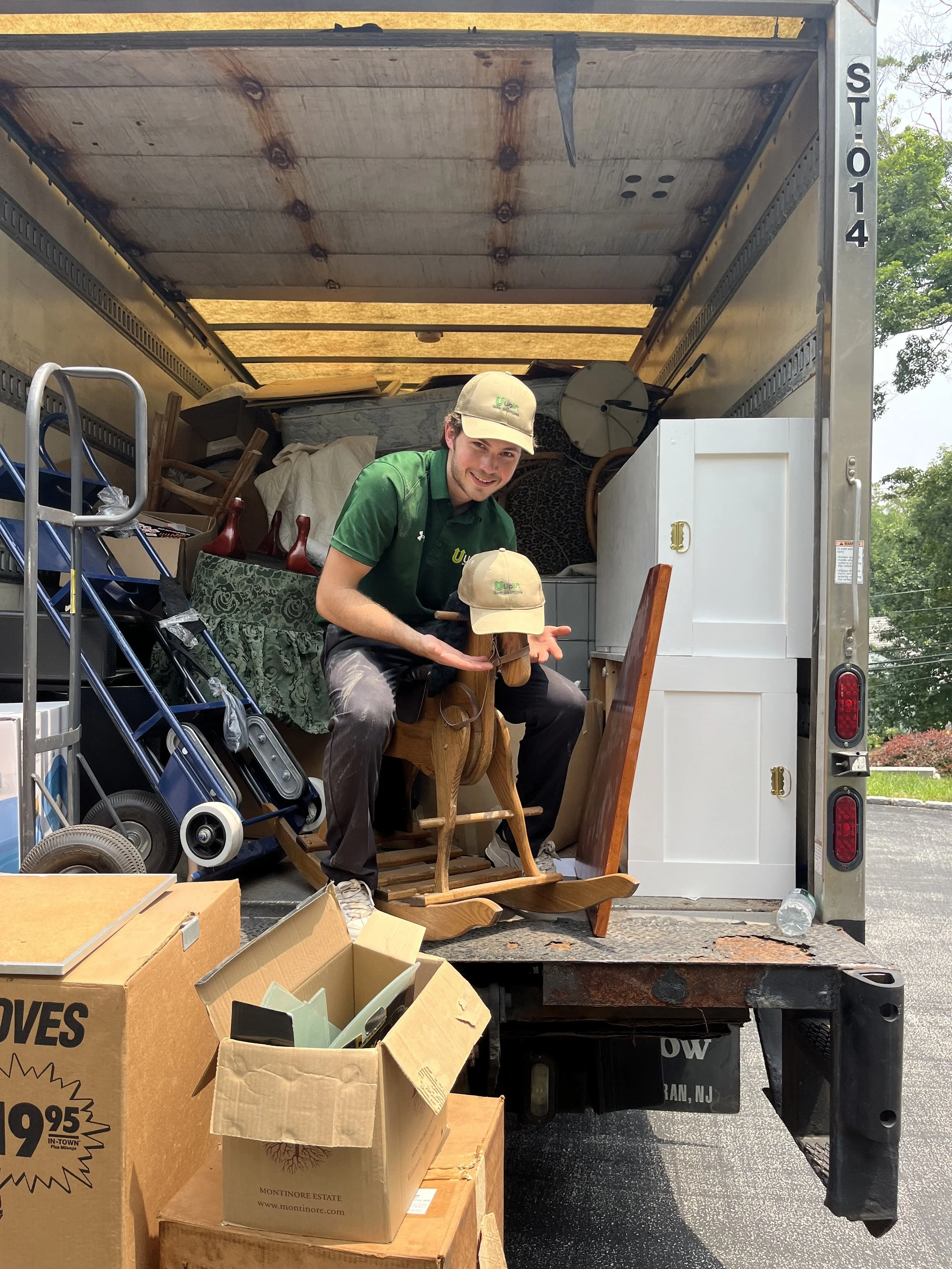 Uplift Junk Solutions team member removing a child's toy during a residential cleanout in Center City.