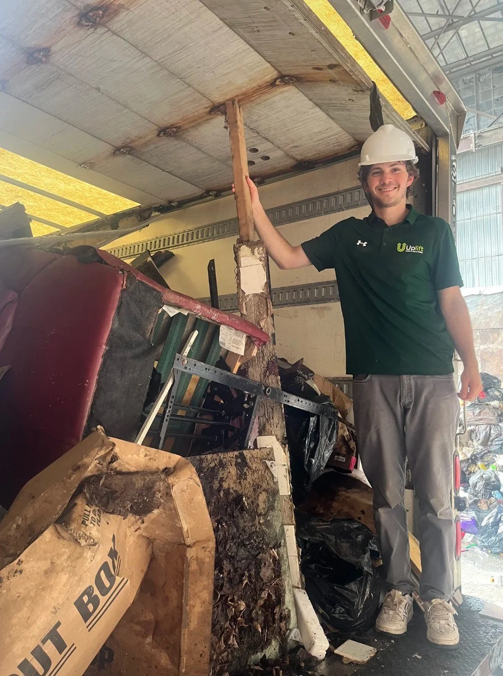Uplift Junk Solutions team member with safety gear during a demolition debris cleanout in the Pennsylvania suburbs.