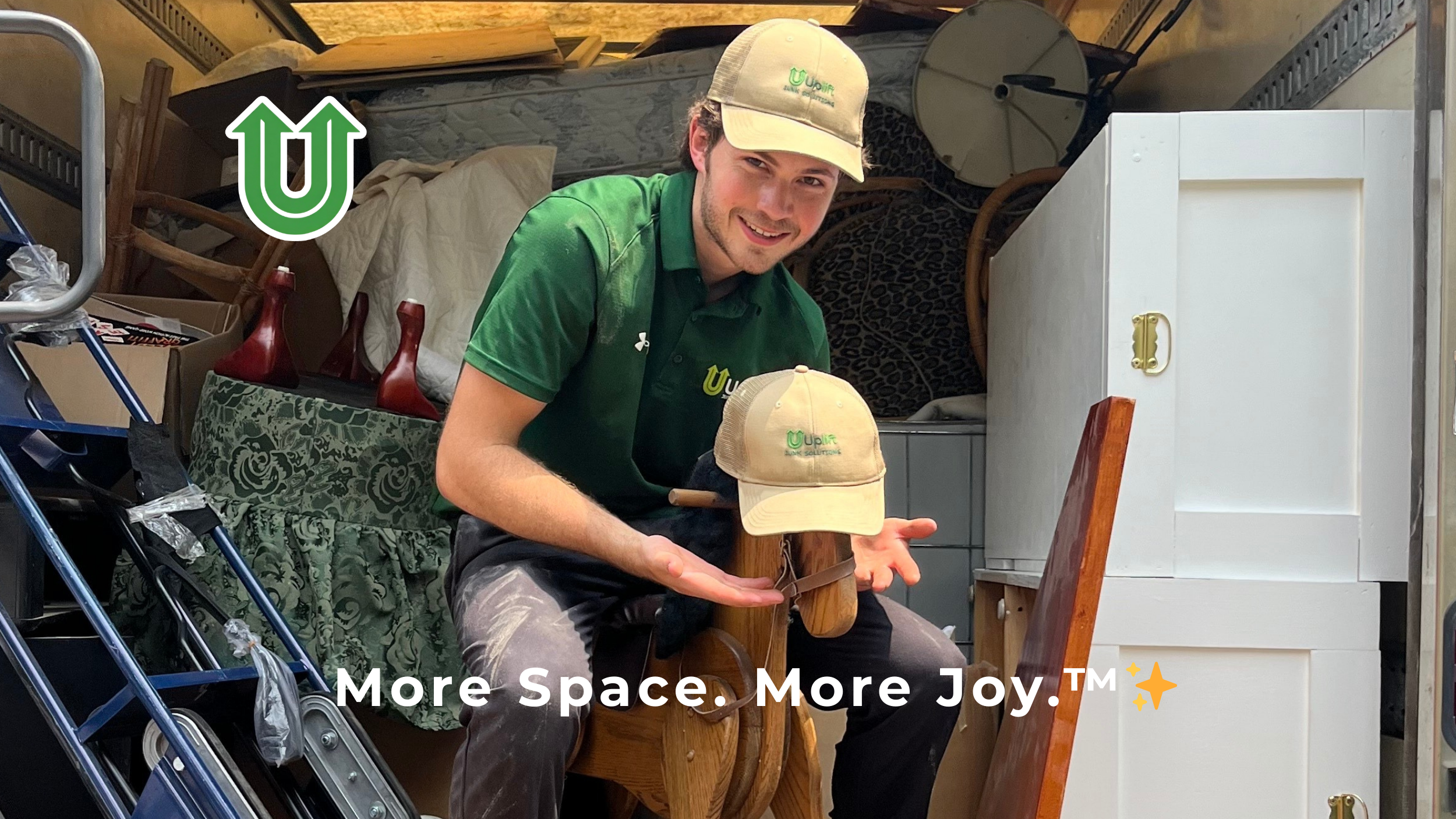 Branded photo from Uplift Junk Solutions showing a team member removing a child's toy during a cleanout in Center City, Philly. The image features the green Uplift “U” brand mark and the ‘More Space. More Joy.™ ✨’ tagline.
