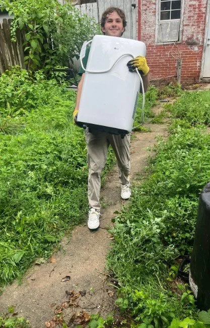Tristan, Uplift Junk Solutions founder, removing an old washing machine from a home in the Pennsylvania suburbs.