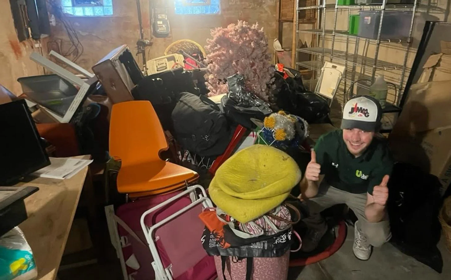 Uplift Junk Solutions team member giving a thumbs-up after a basement cleanout in Philadelphia.