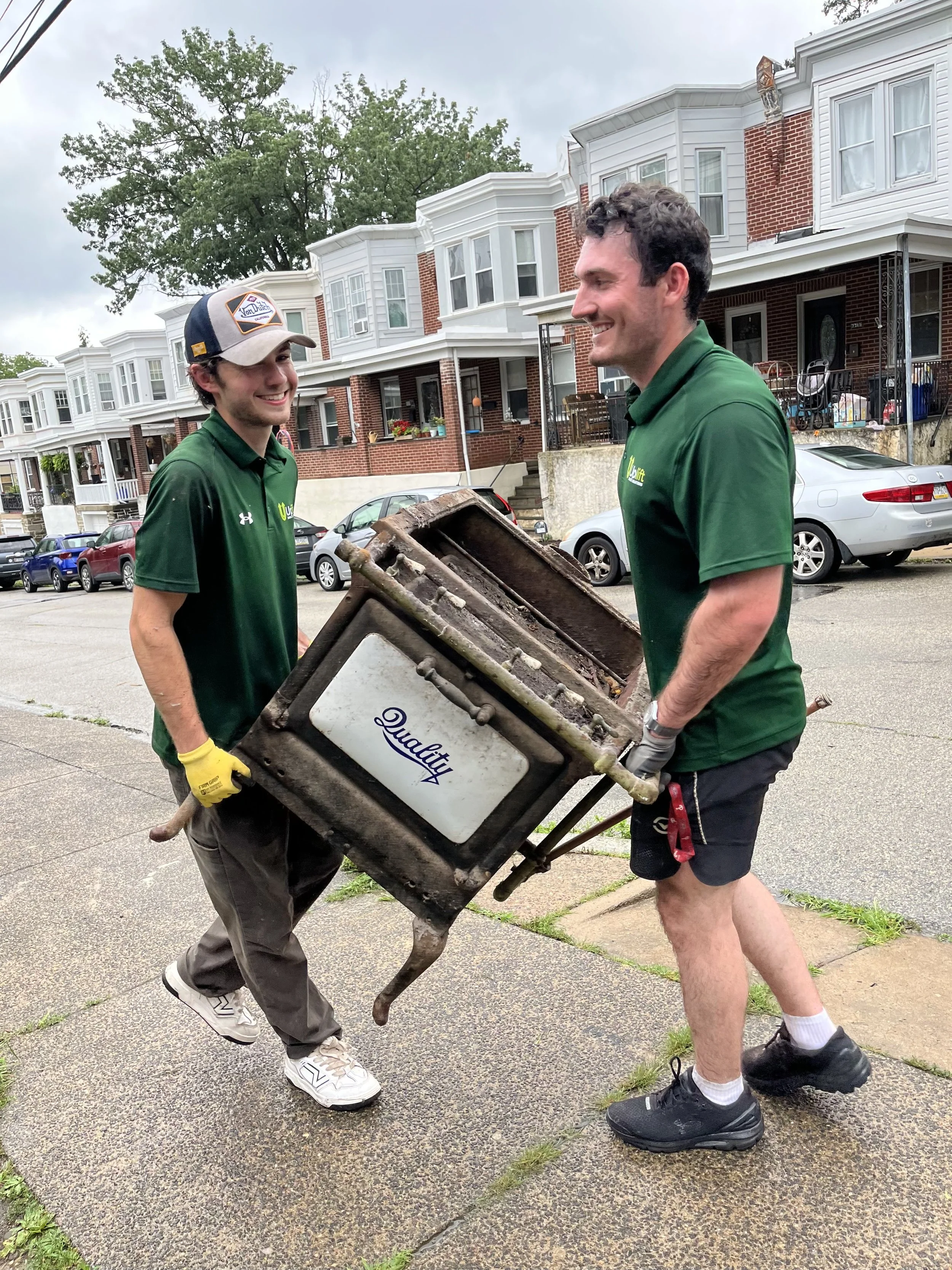 Uplift Junk Solutions team removing an old stove from a residential home in Philadelphia.