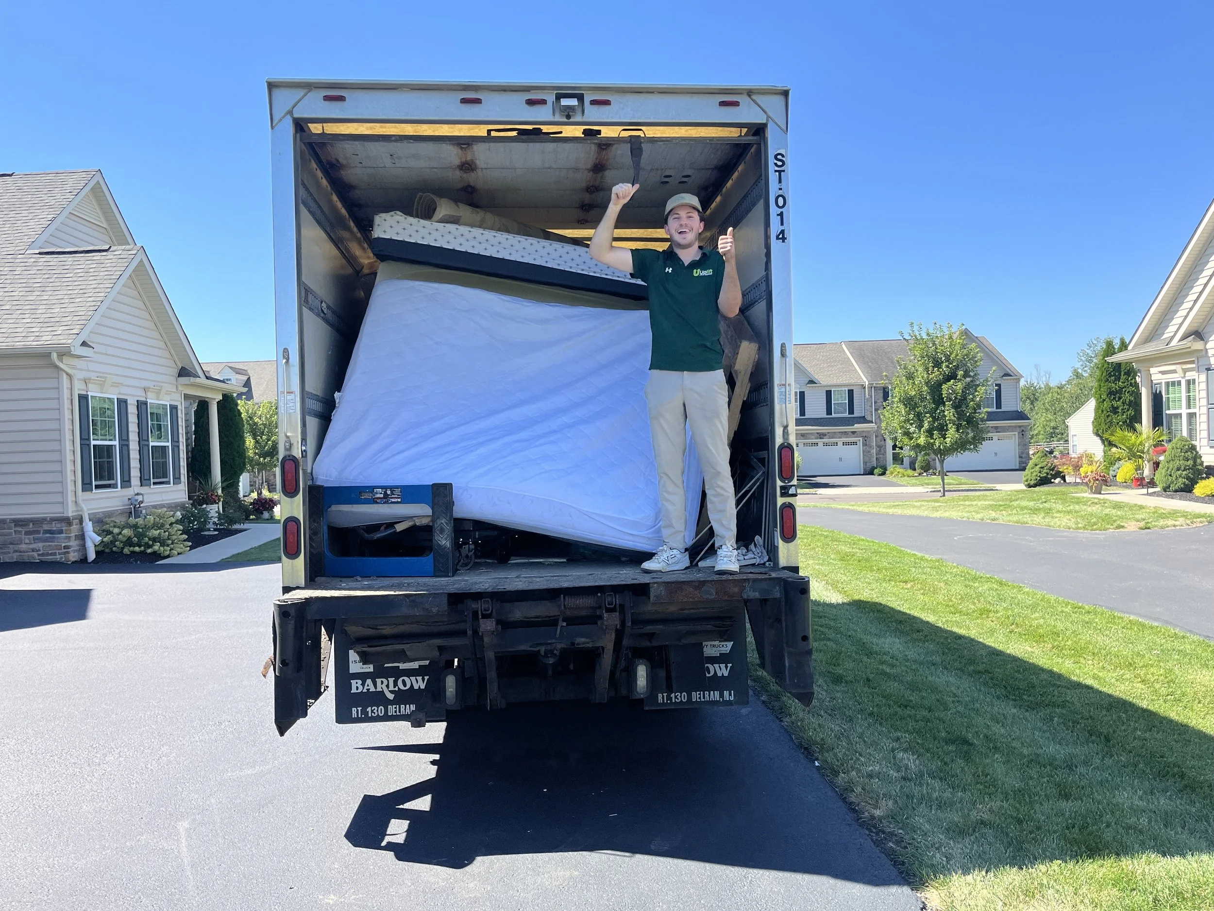 Uplift Junk Solutions team giving a thumbs-up for a successful mattress removal in the Pennsylvania suburbs.