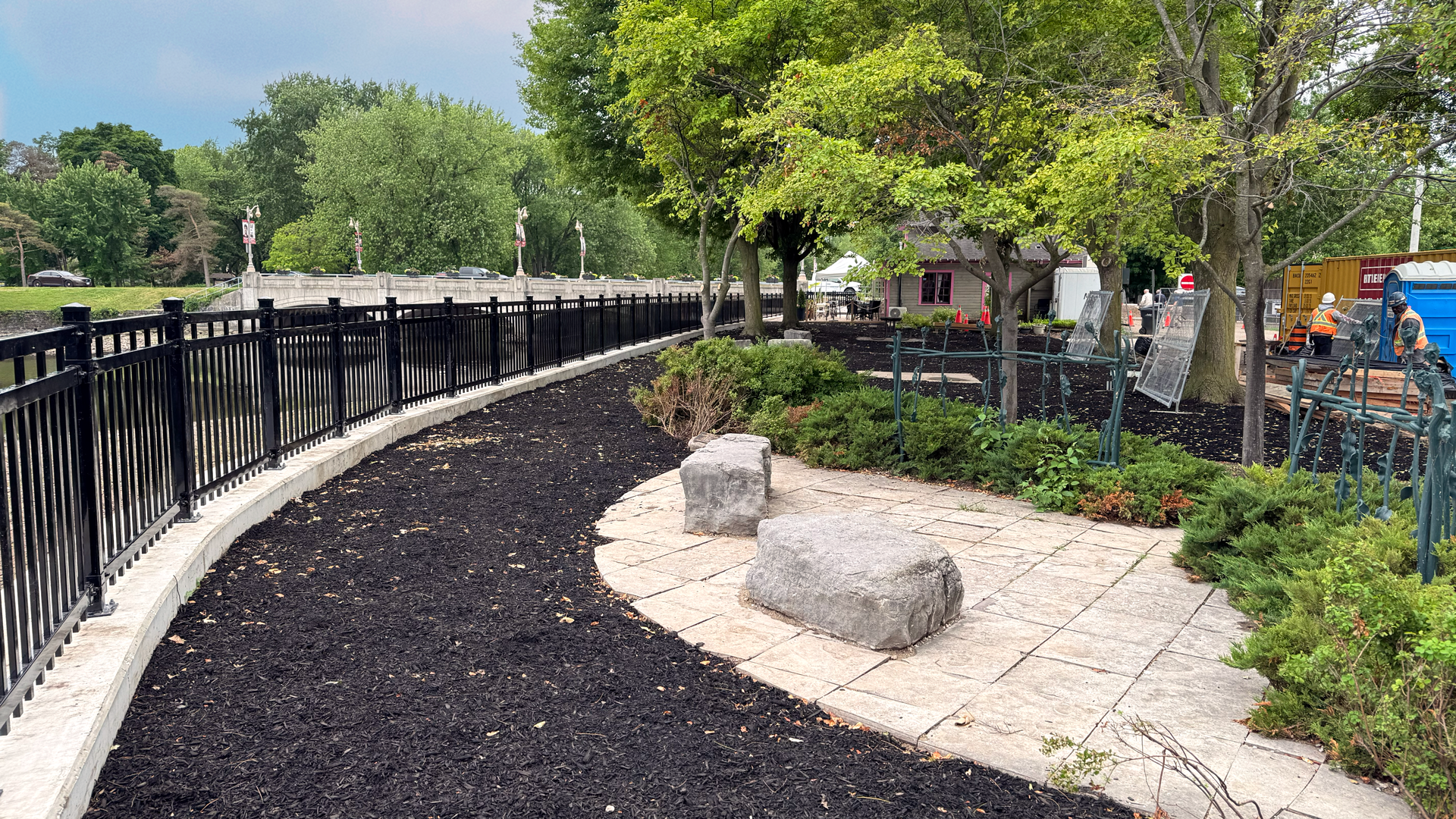 The updated Reflecting Garden, completed as part of the Boathouse retaining wall rehabilitation in 2025, Guelph, Ontario. Two large stone are place for conveniently for sitting and looking out over the river.