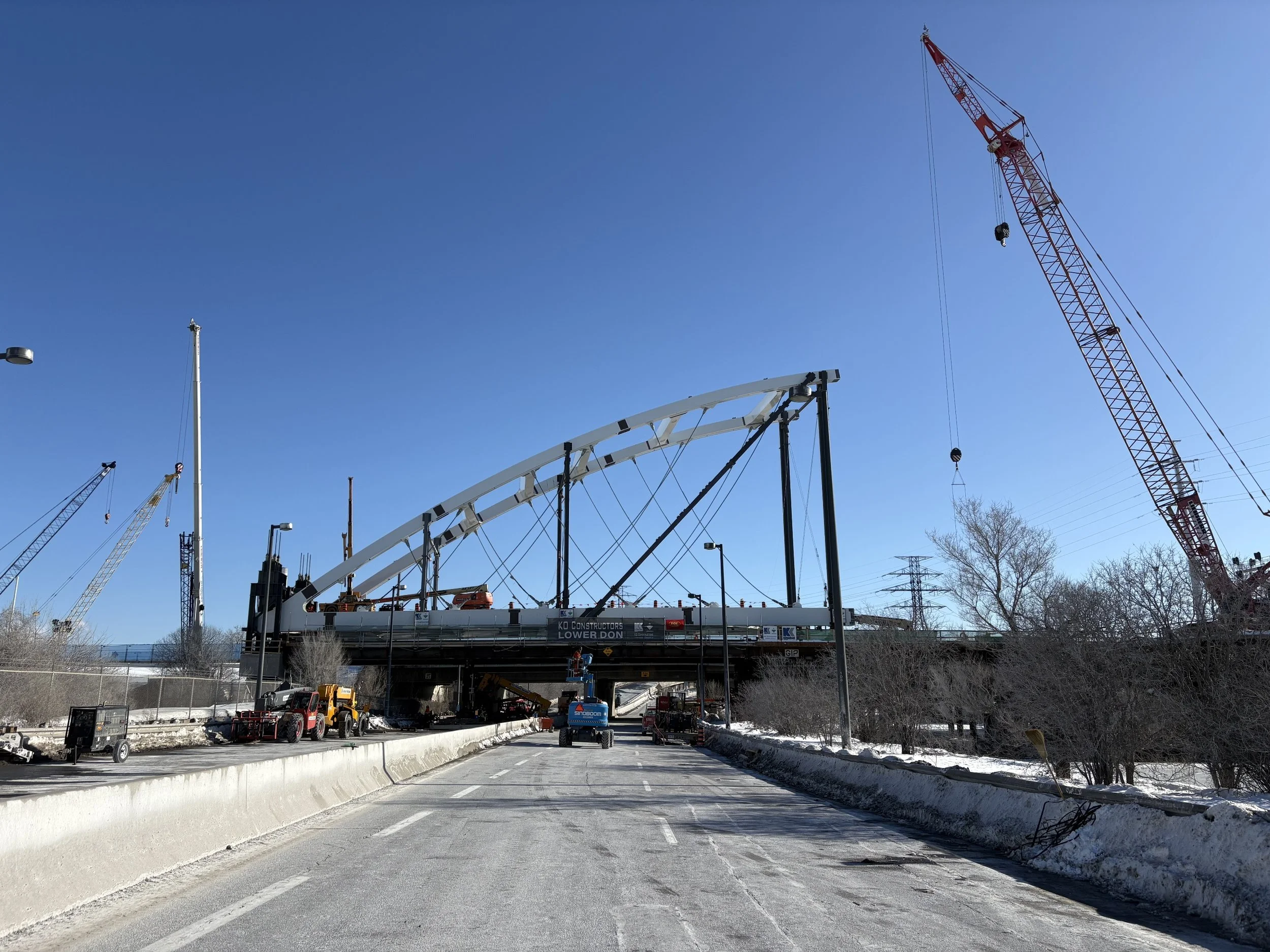Image taken from the below the bridge, looking up at the recently launched arch for the Don Valley Parkway Bridge. The arch launch took place over a very narrow closure window.