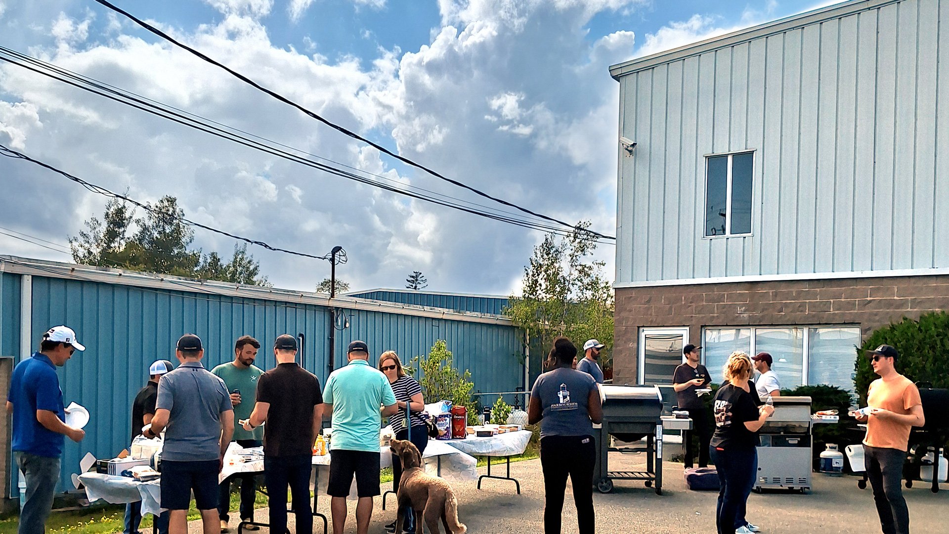 Harbourside staff start lining up for the first few BBQ items being served during the welcome party for the new materials testing laboratory.