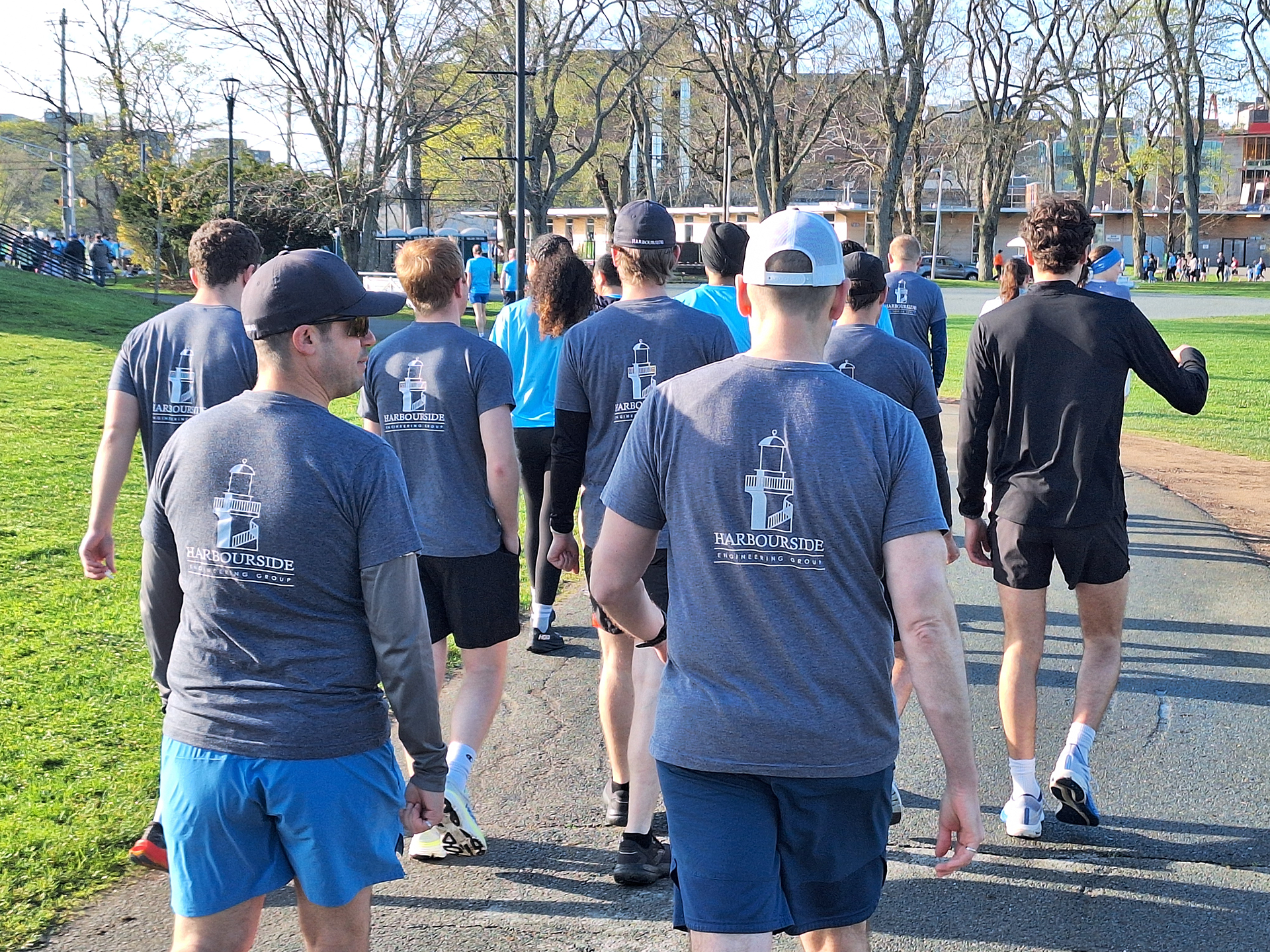 Warm up complete, the Harbourside Engineering team from Dartmouth makes their way towards the start line of the Blue Nose Marathon Purple Cow 5km run.