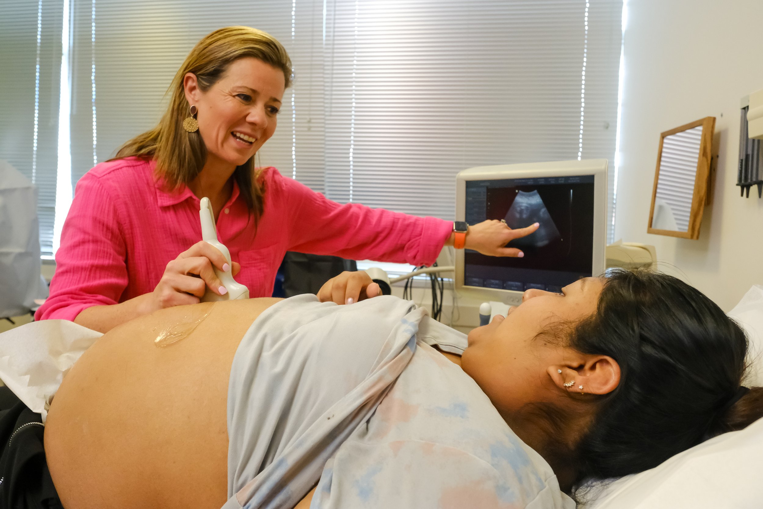 Female doctor giving a pregnant woman an ultrasound