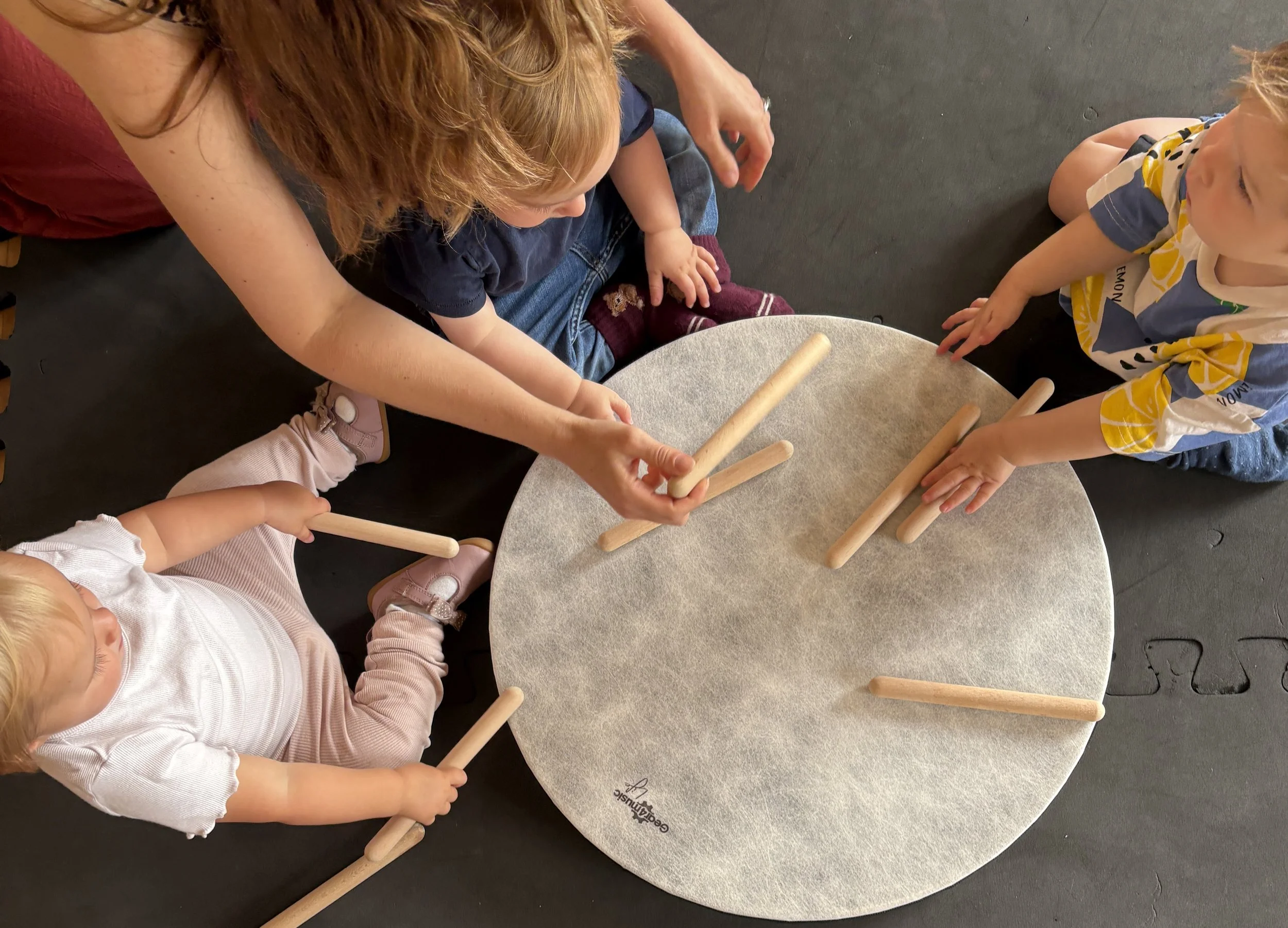 Toddlers play big drum, baby toddler music classes Alfold Surrey, west Sussex, Mini Musicians
