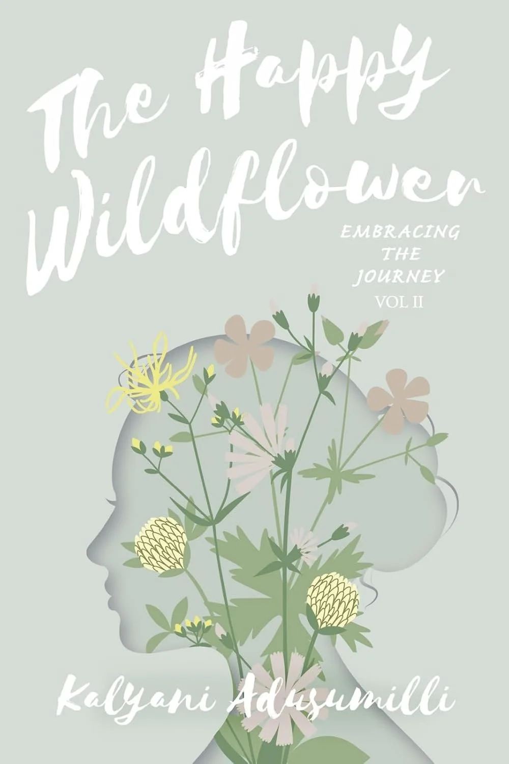 Book cover titled 'The Happy Wildflower' with the subtitle 'Embracing the Journey Vol 2' and author's name Kalyani Adsumilli. The cover features a silhouette of a person's profile filled with various wildflowers and plants in pastel colors.