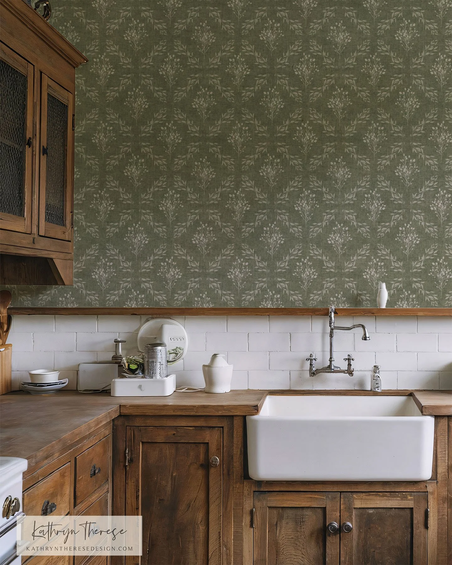 Kitchen with white farmhouse sink, wooden cabinets, and green floral wallpaper.