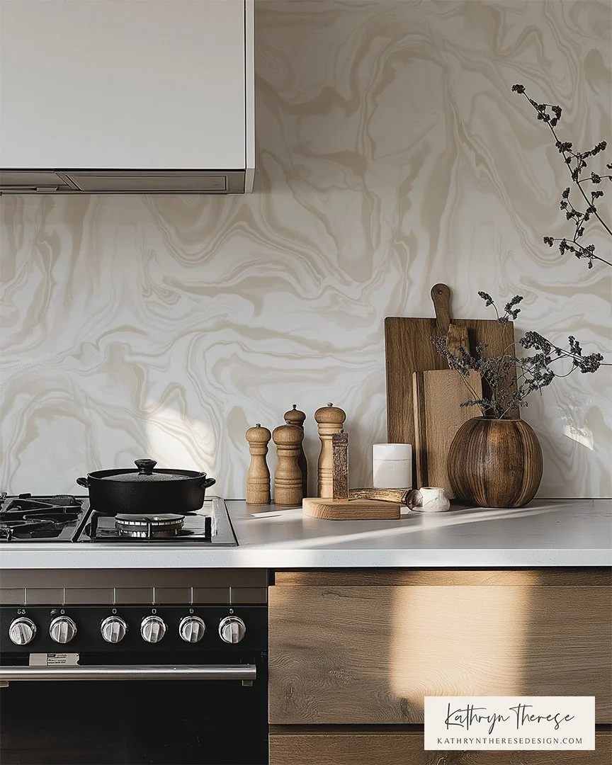 Modern kitchen countertop with a black pot on a stove, wooden salt and pepper shakers, and various wooden kitchen accessories including cutting boards and vases with dried branches, with a beige marble-patterned backsplash.