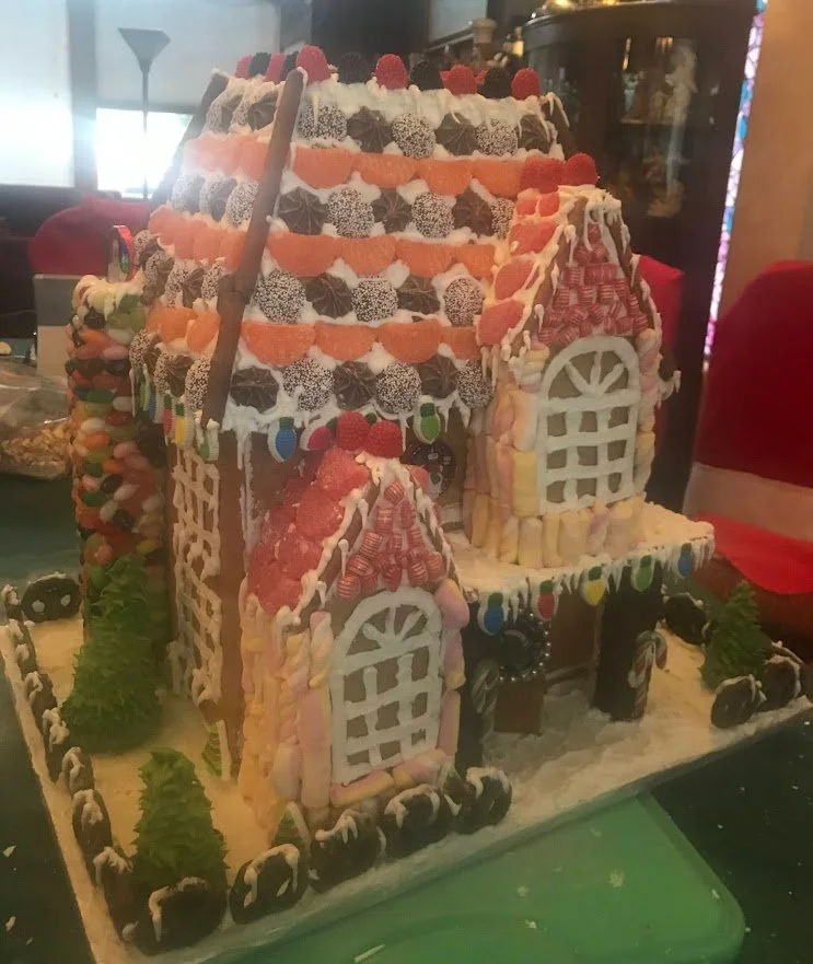 Victorian Gingerbread House Chocolate and Fruit Candies on Roof Jelly Bean Fireplace Chocolate Covered Pretzel Fence Colorful Marshmallow Windows Royal Icing Christmas Lights and Sugar Cone Trees Hard Mint Candy Gables  