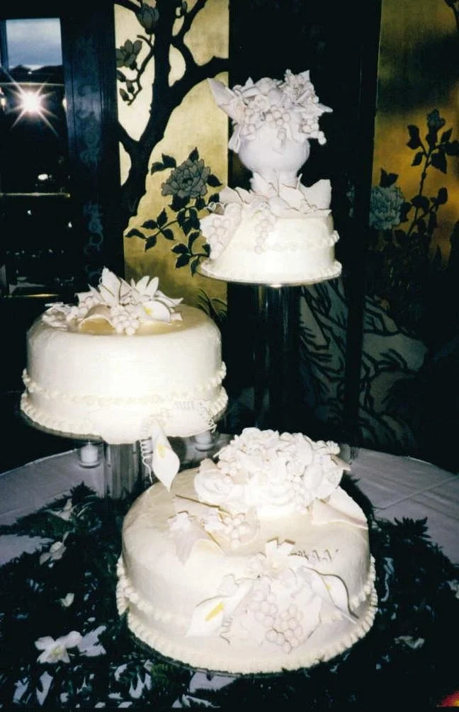 Three separate crystal cake pillars and stands Formal Elegant British inspired Wedding cake with intricate sugar porcelain fruit and flower sculpted bowl arrangements  Callas Roses Bundled Grapes overflowing 