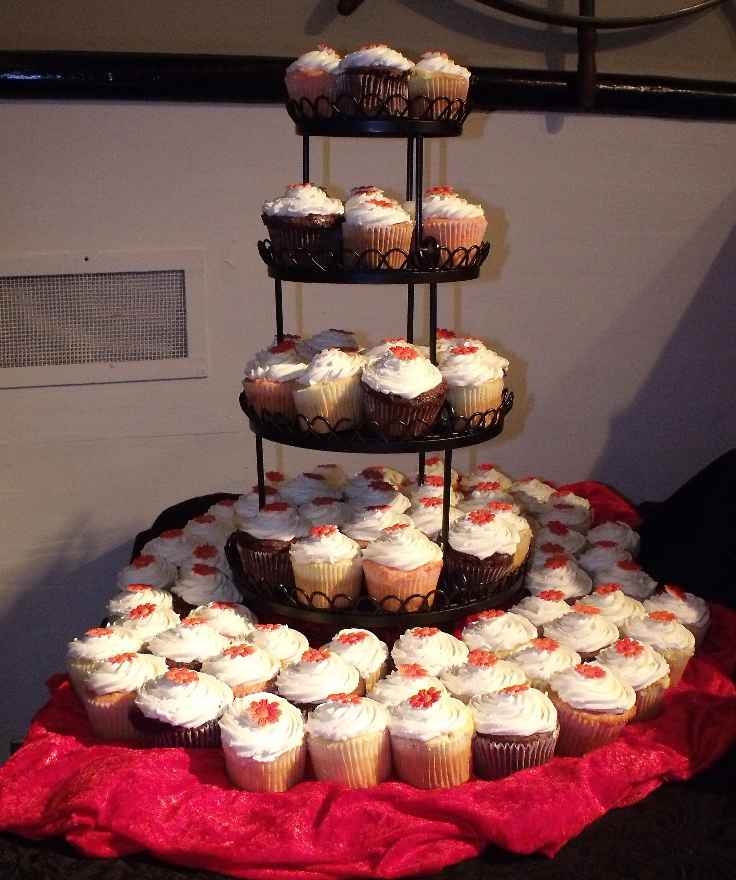 Wedding Cupcake Celebration Four Tier  Tower Sitting on Bunched Red Linen