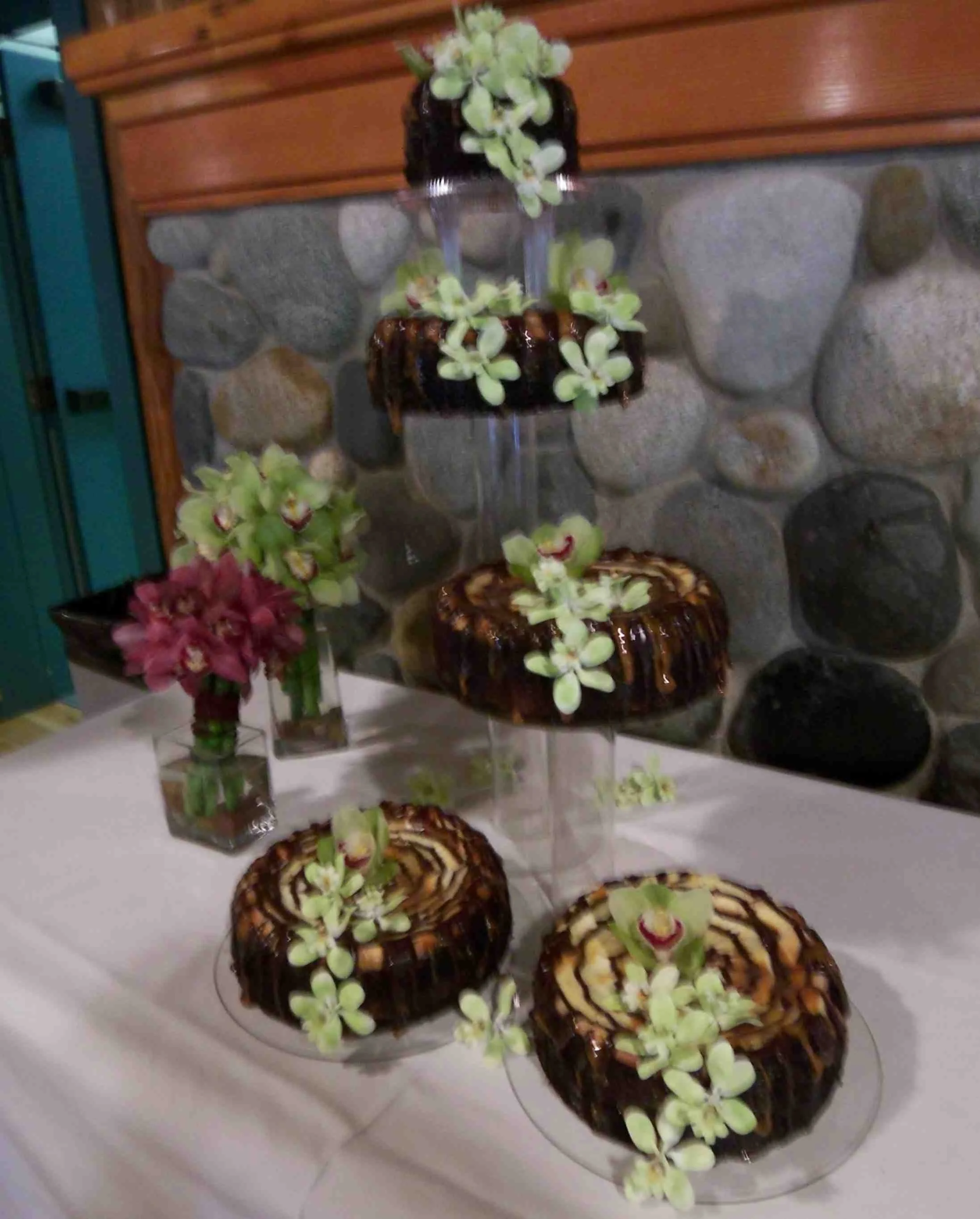 Green Sugar Porcelain Orchids with one Real Orchid blossom cascades on each of Five Tier Chocolate Swirl Wedding Cheesecake 