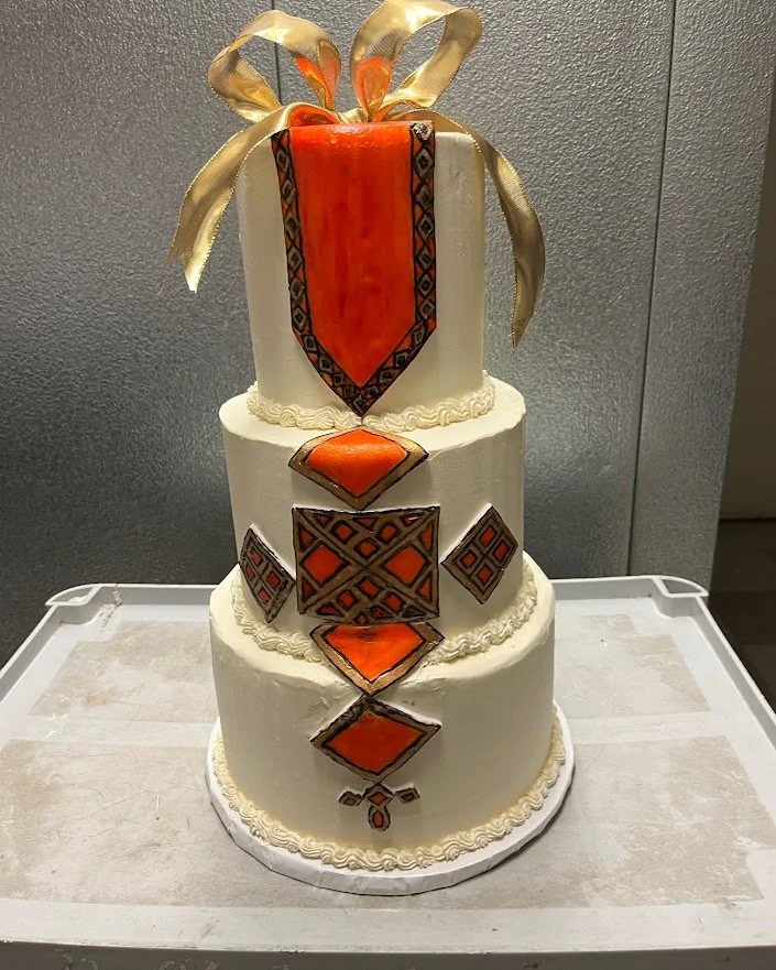 Haitian Wedding Cake Design Hand colored on Fondant Applique Gold Bow Three Stacked Smooth Side Rounded Edge Tiers