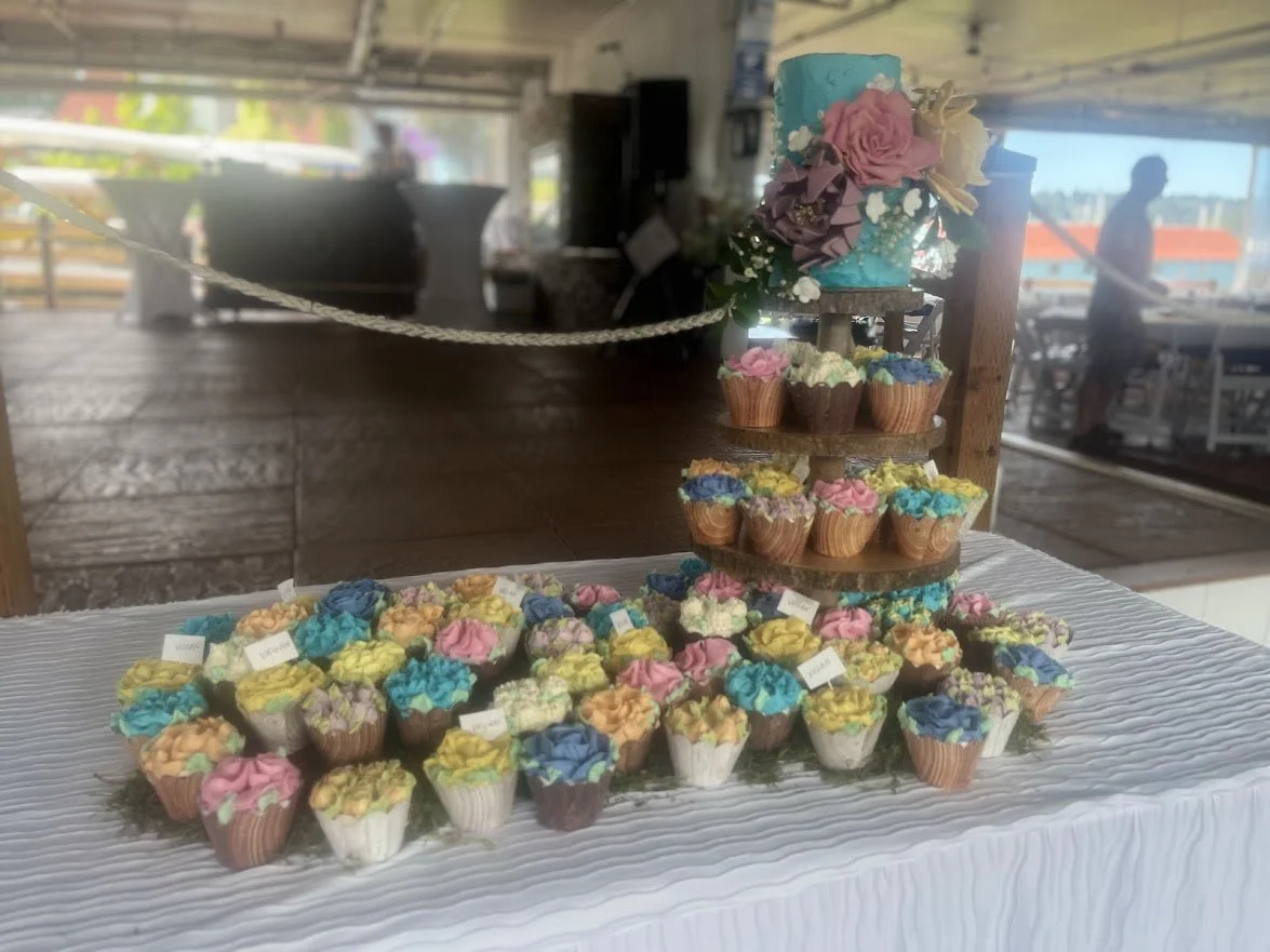 Rustic Wedding Cake and Cupcakes Wood Tower with Table Scattered Brightly Colored Piped Flower Bud Cupcakes on Moss and Large Impressionistic Fondant Flowers on Top Cake 