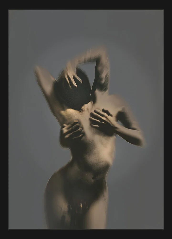 A blurred sculpture of a nude human figure holding a dark ball, with multiple hands arranged on the body, against a plain background.