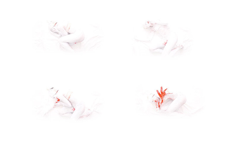 Four images of a person in white clothing with red paint on their face and hands, lying on a white surface in different positions.