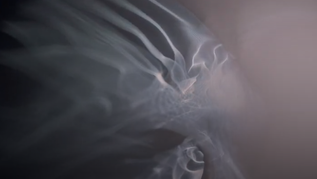 Abstract image with wisps of smoke or fog swirling in dark and light shades.