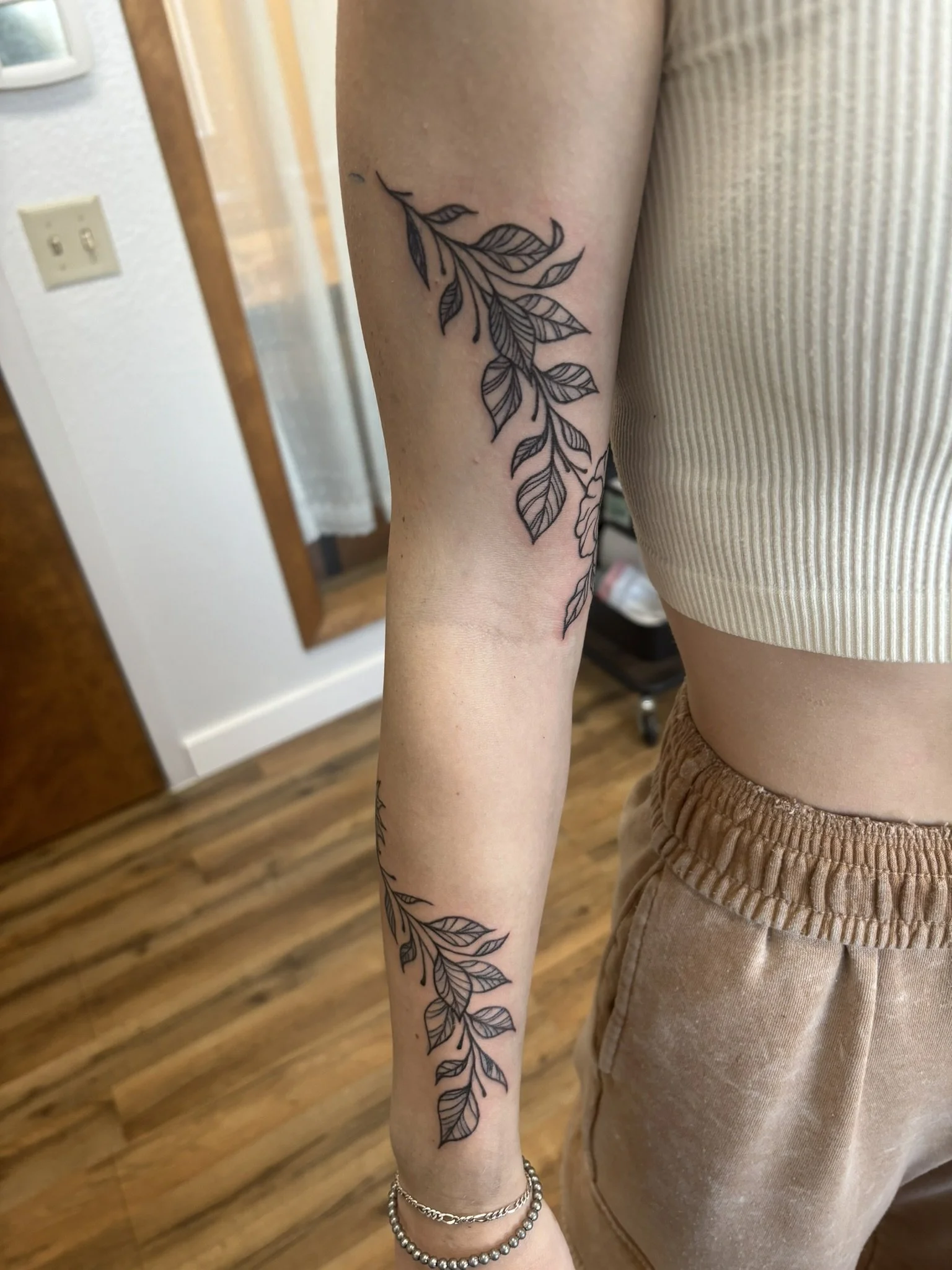  Fine line floral arm wrap black ink tattoo  