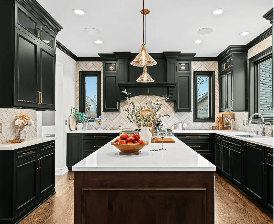 Modern kitchen with Few Oaks Platinum Series Cabinets, white countertops, central island, pendant lights, and a bowl of fruit.