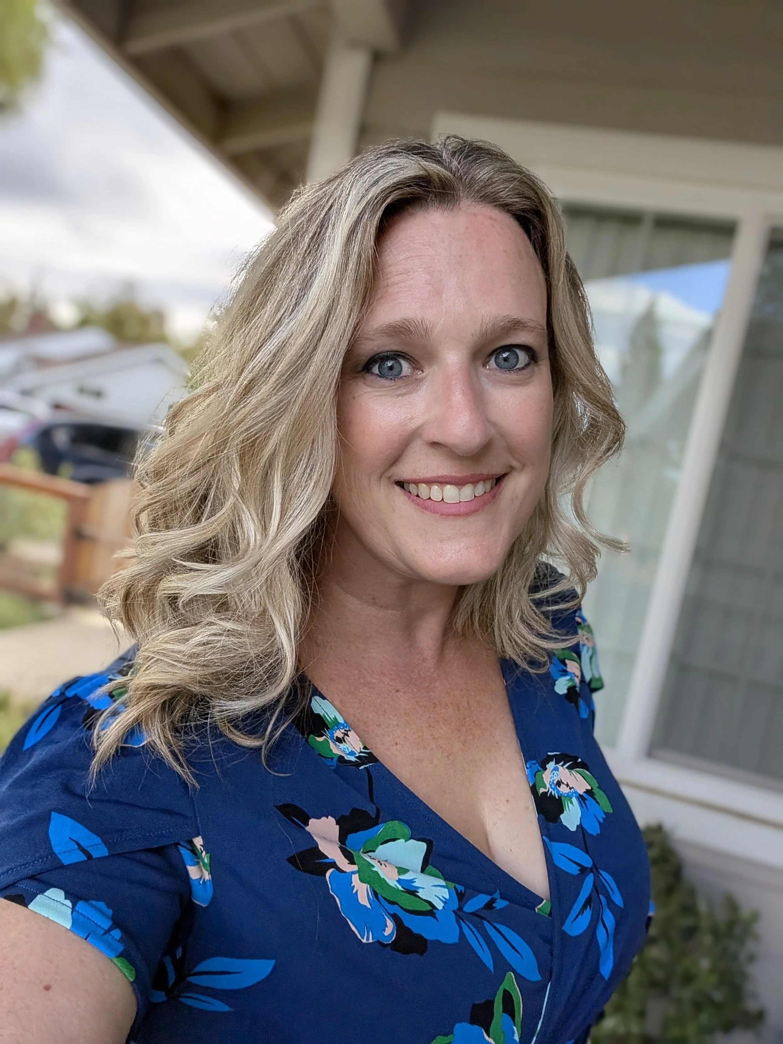 Photo of a blonde woman in a blue shirt.