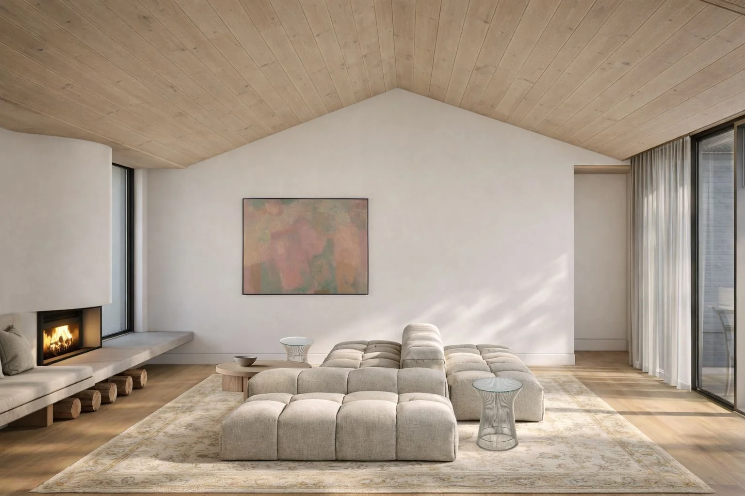 Modern living room with beige sectional sofa, small side tables, fireplace, light wood ceiling, sliding glass doors with white curtains, abstract wall art, and a patterned area rug.