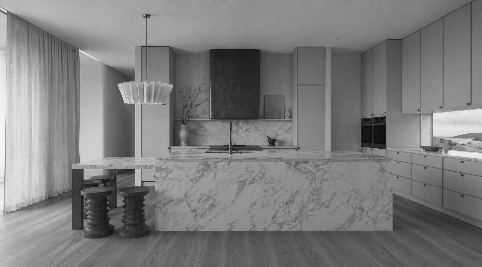Modern kitchen with marble island, cabinetry, and a view of landscape through window