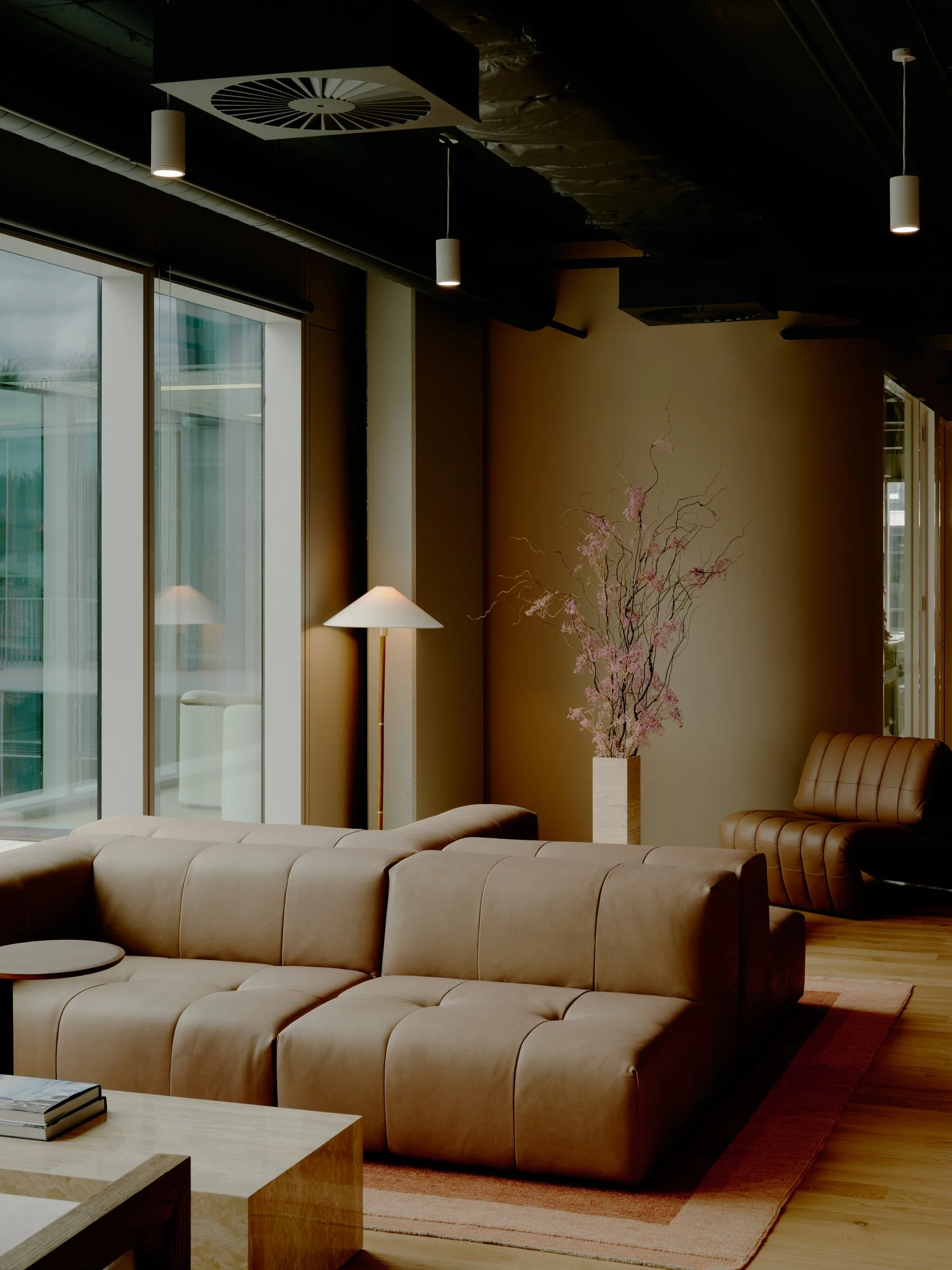 River Street office lounge area with sectional sofa and warm lighting