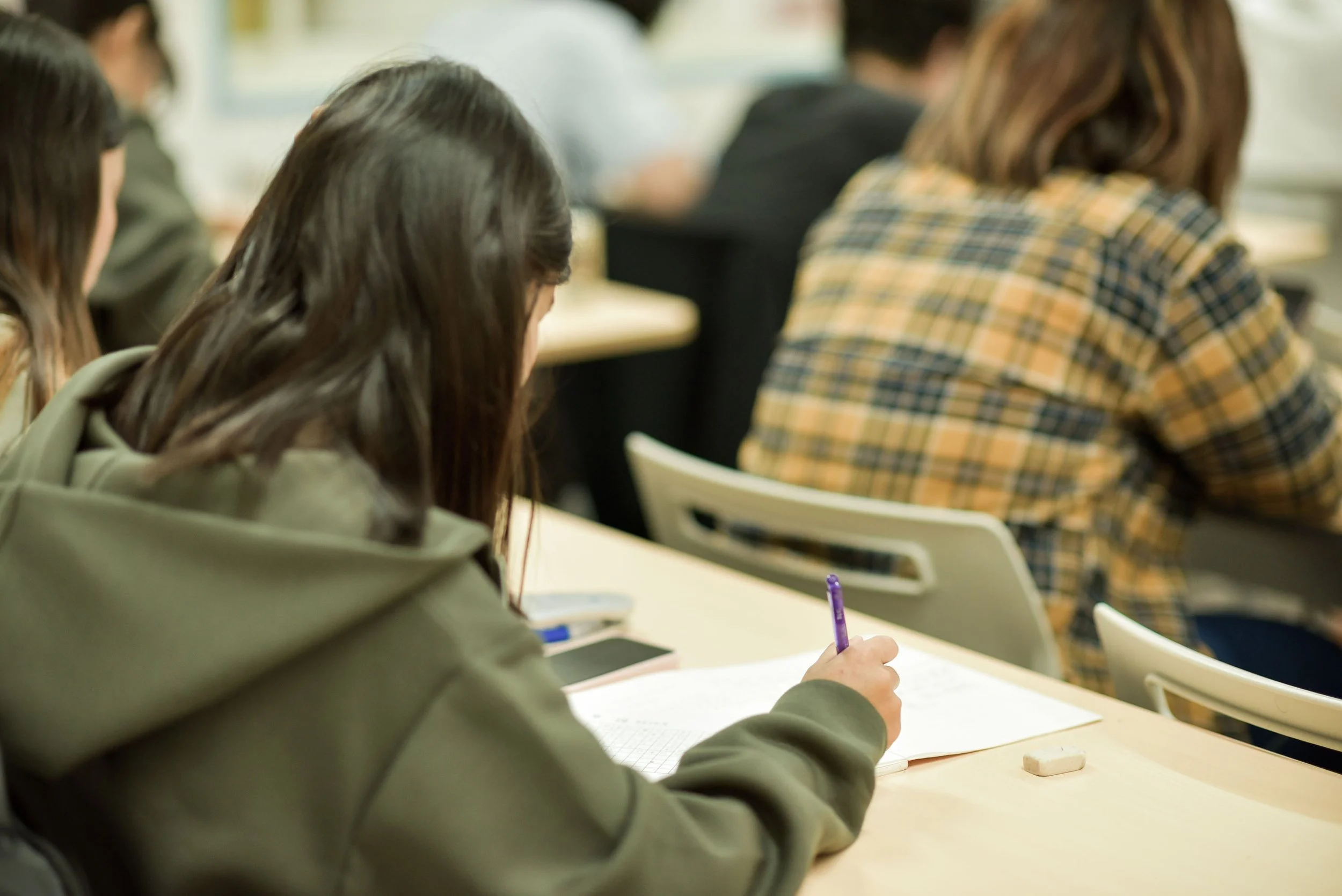 Japanese language school students in class writing