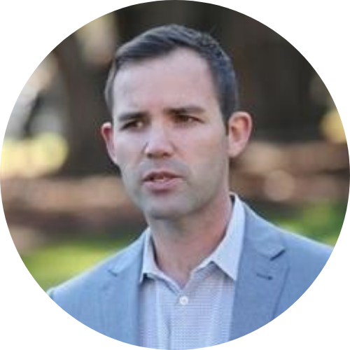 Portrait of Mat Tinkler wearing a blue suit