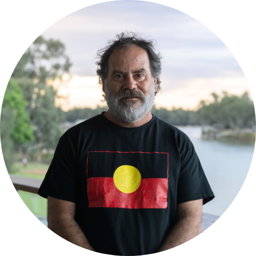 Portrait of Brendan Kennedy facing the camera, standing on a bridge