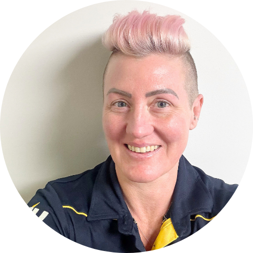 Jo Sutton - with pink hair and wearing an ETU shirt in navy and yellow.